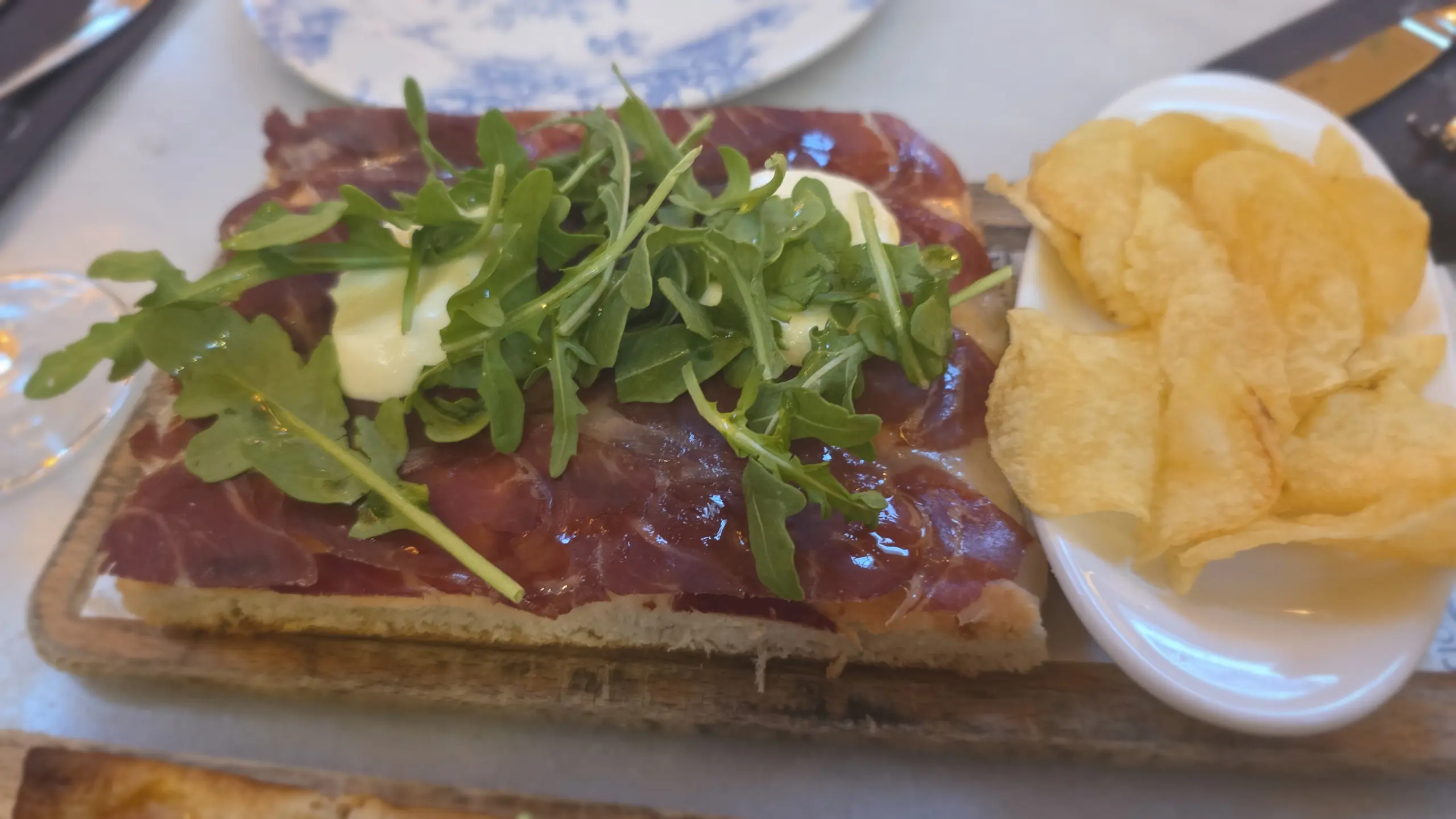 Homemade flat bread with Iberian ham, mozzarella and rocket, La Parada, El Nacional, Barcelona, Spain
