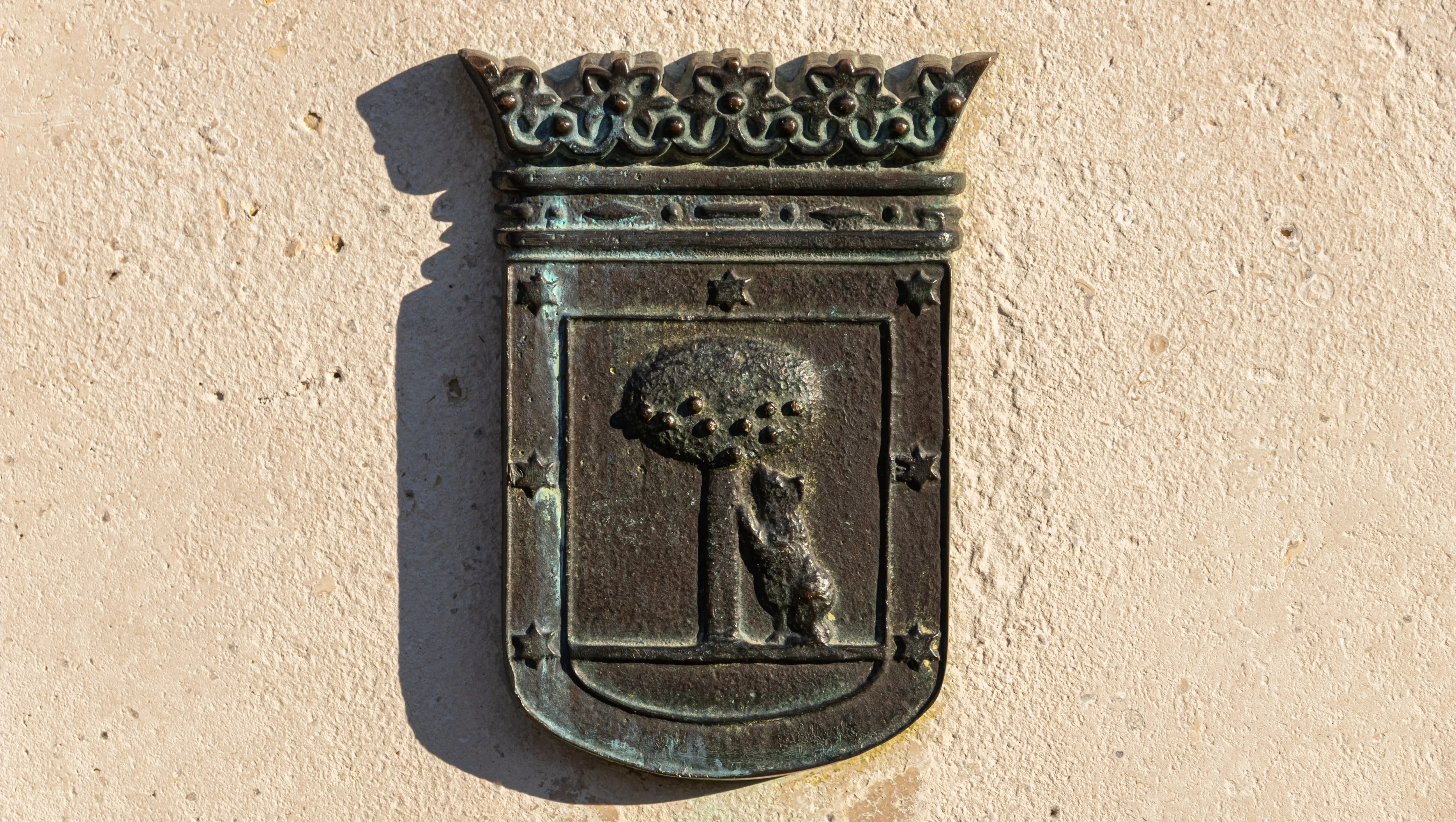 Bronze relief of Madrid’s coat of arms featuring the bear and the strawberry tree, Madrid, Spain