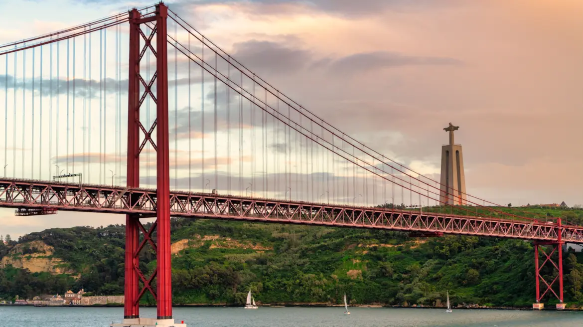 The 25 de Abril Bridge and the Sanctuary of Christ the King (Santuário de Cristo Rei), Lisbon, Portugal
