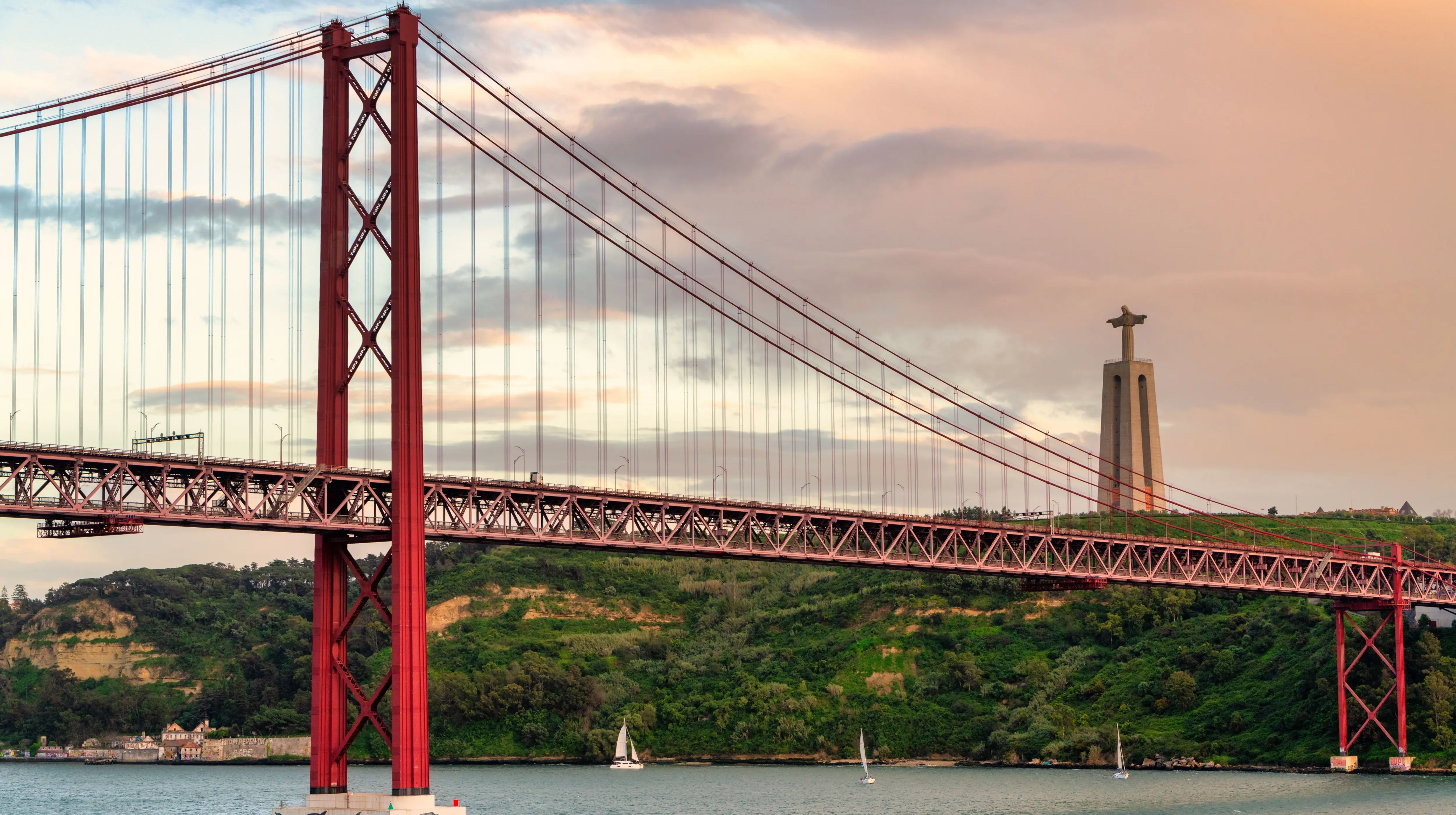 The 25 de Abril Bridge and the Sanctuary of Christ the King (Santuário de Cristo Rei), Lisbon, Portugal