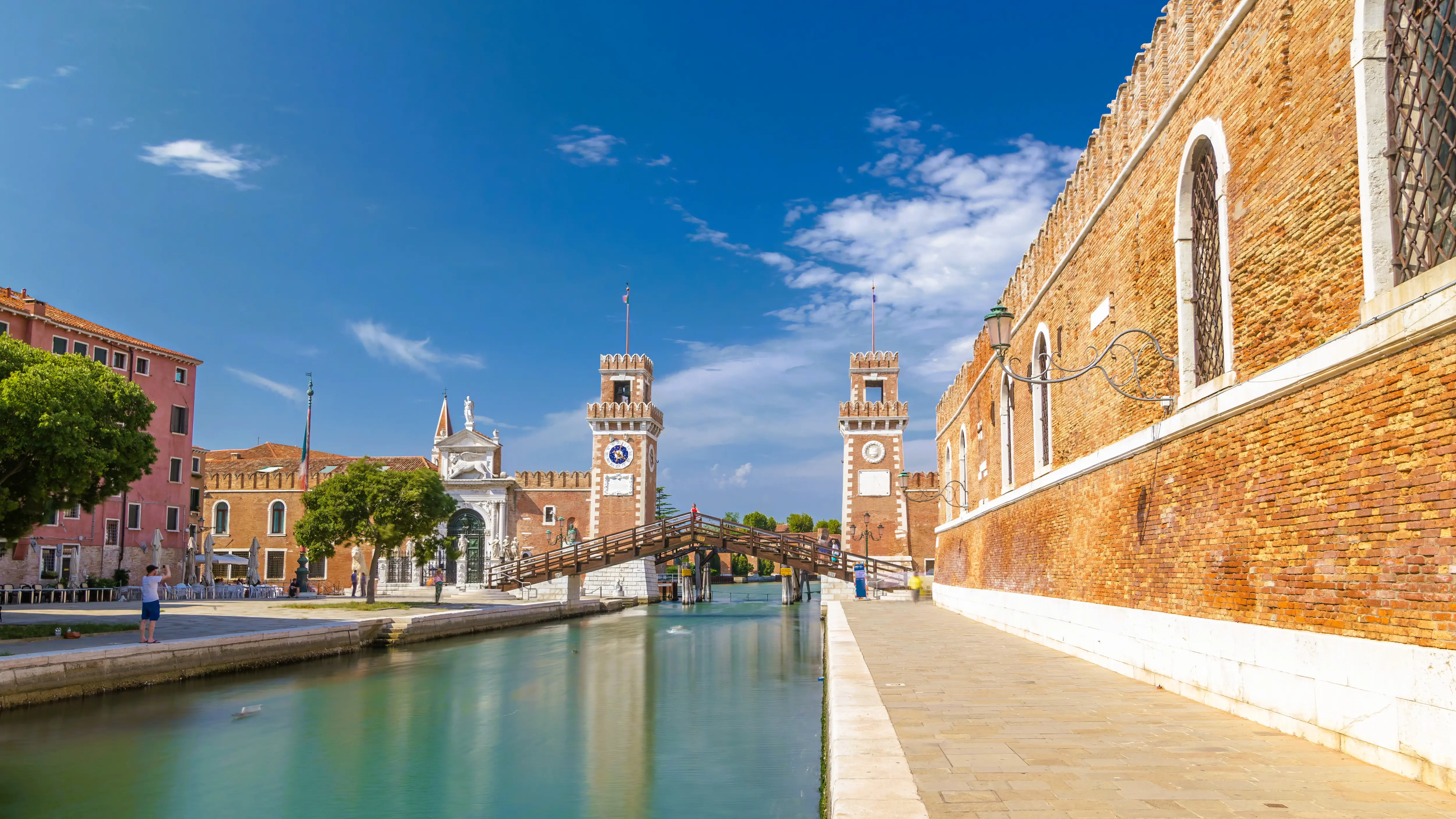 Entrance historic Arsenale Castello district Venice Italy featuring Campo de l'Arsenale canal Ponte dell'Arsenale sunny day