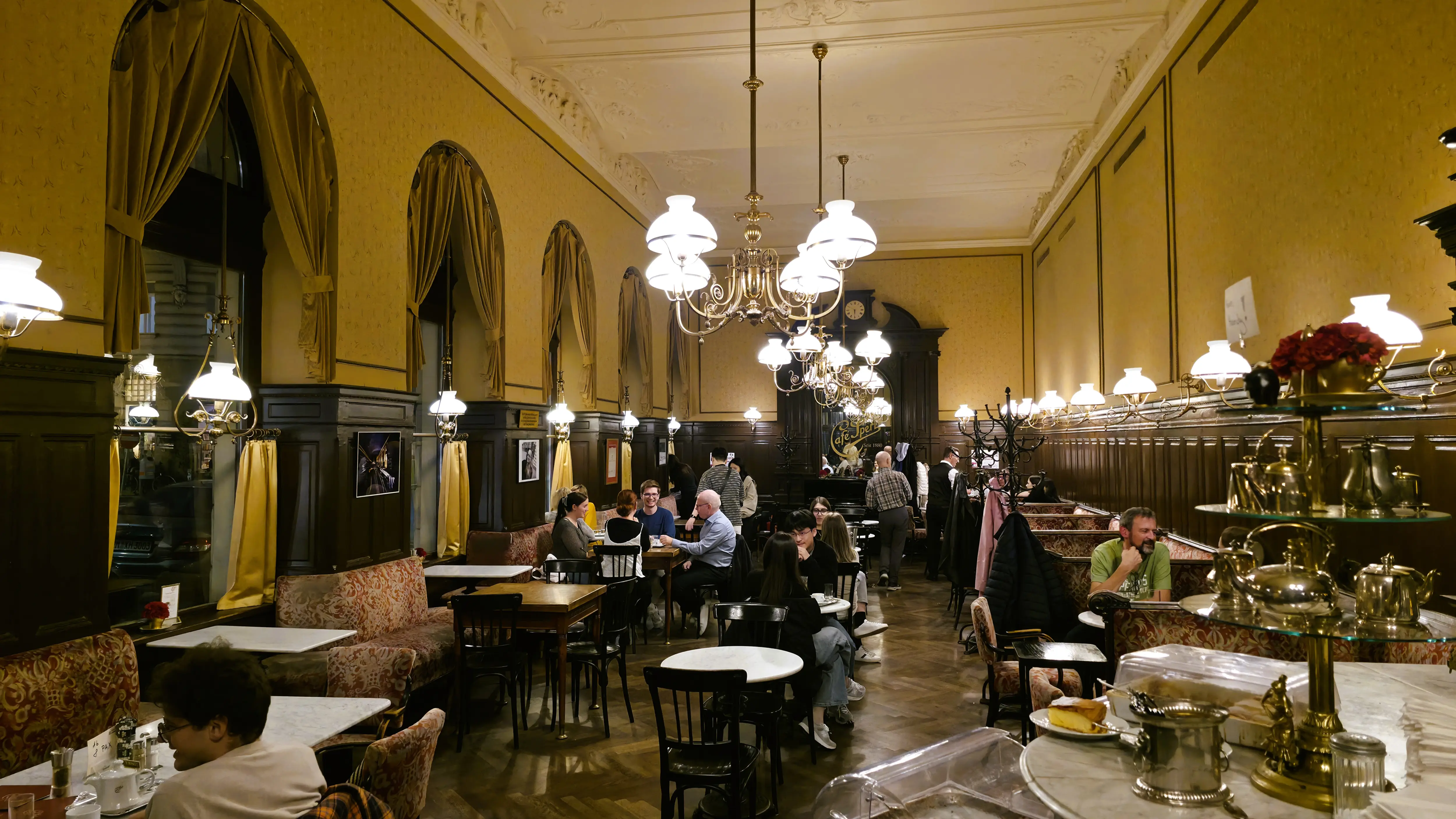 Historic interior Café Sperl Vienna Austria classic wood paneling marble tables billiard tables traditional Viennese coffeehouse décor opened late 19th century locals linger time deliberately unhurried