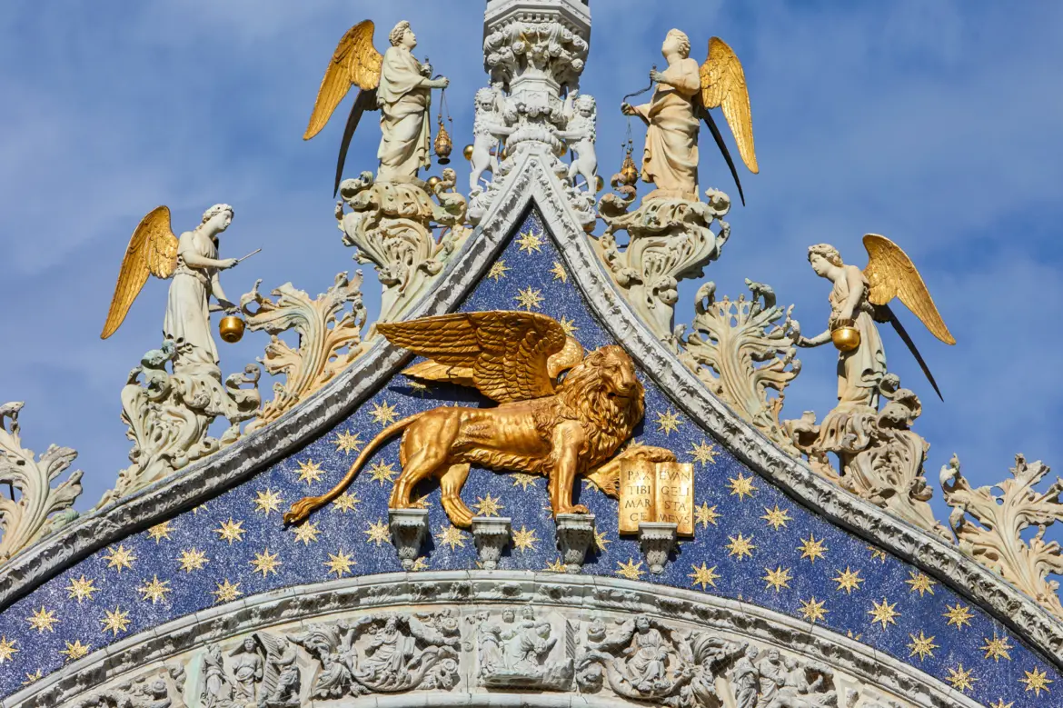 Golden winged Lion of Saint Mark on façade St Mark's Basilica Venice Italy enduring symbol Venice patron saint