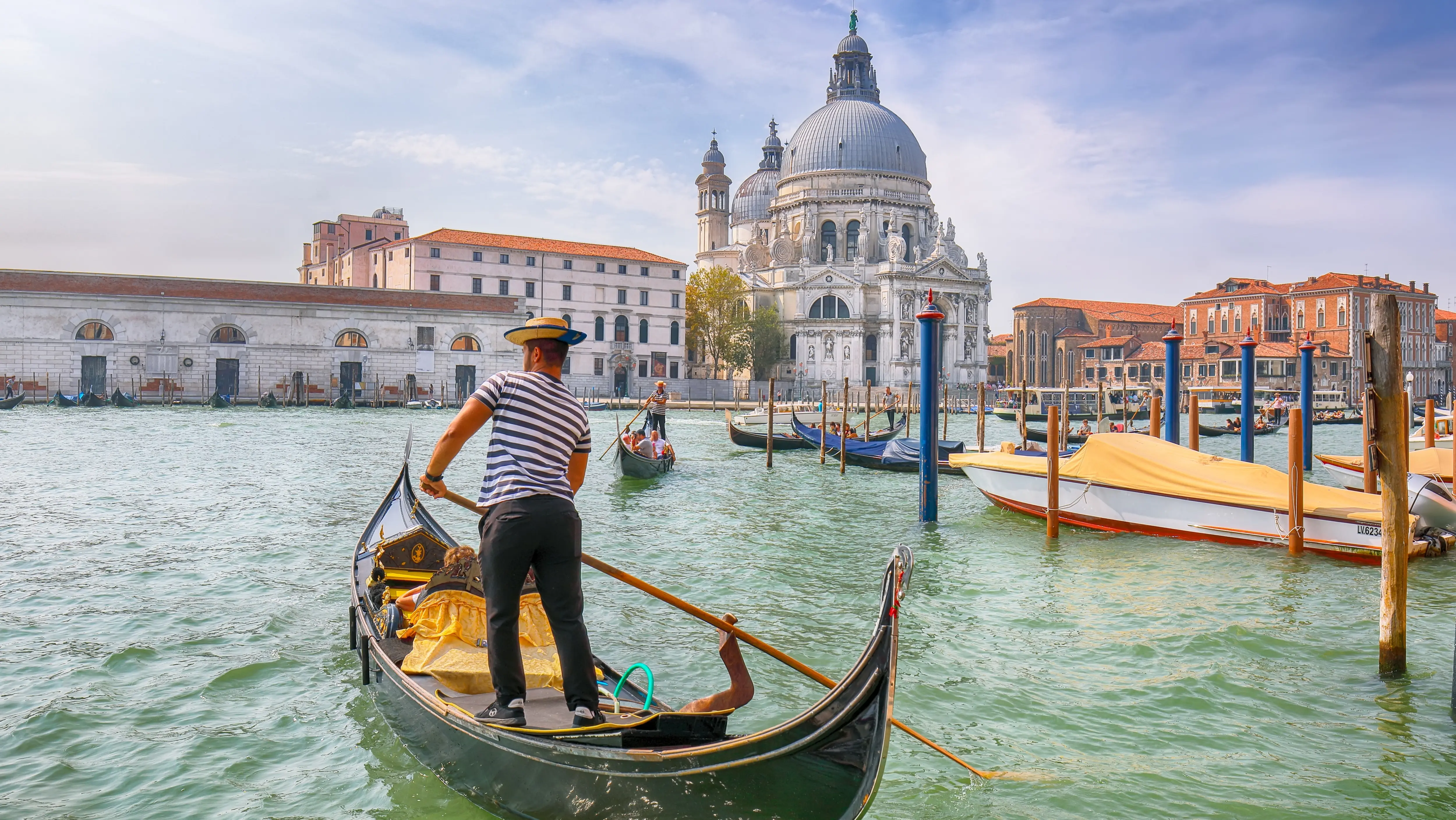 Morning cityscape Venice Grand Canal Santa Maria della Salute gondolier navigating water Venice Italy