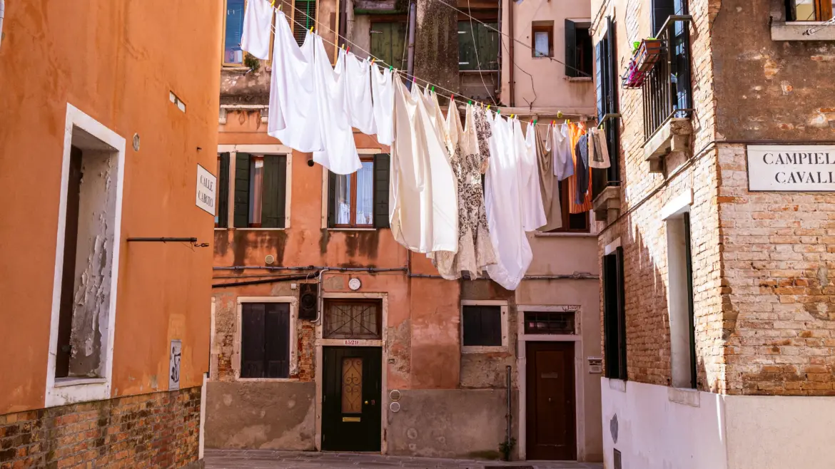 Laundry hanging dry between historic buildings Arsenale neighborhood Castello Venice Italy everyday rhythms local life authentic residential districts