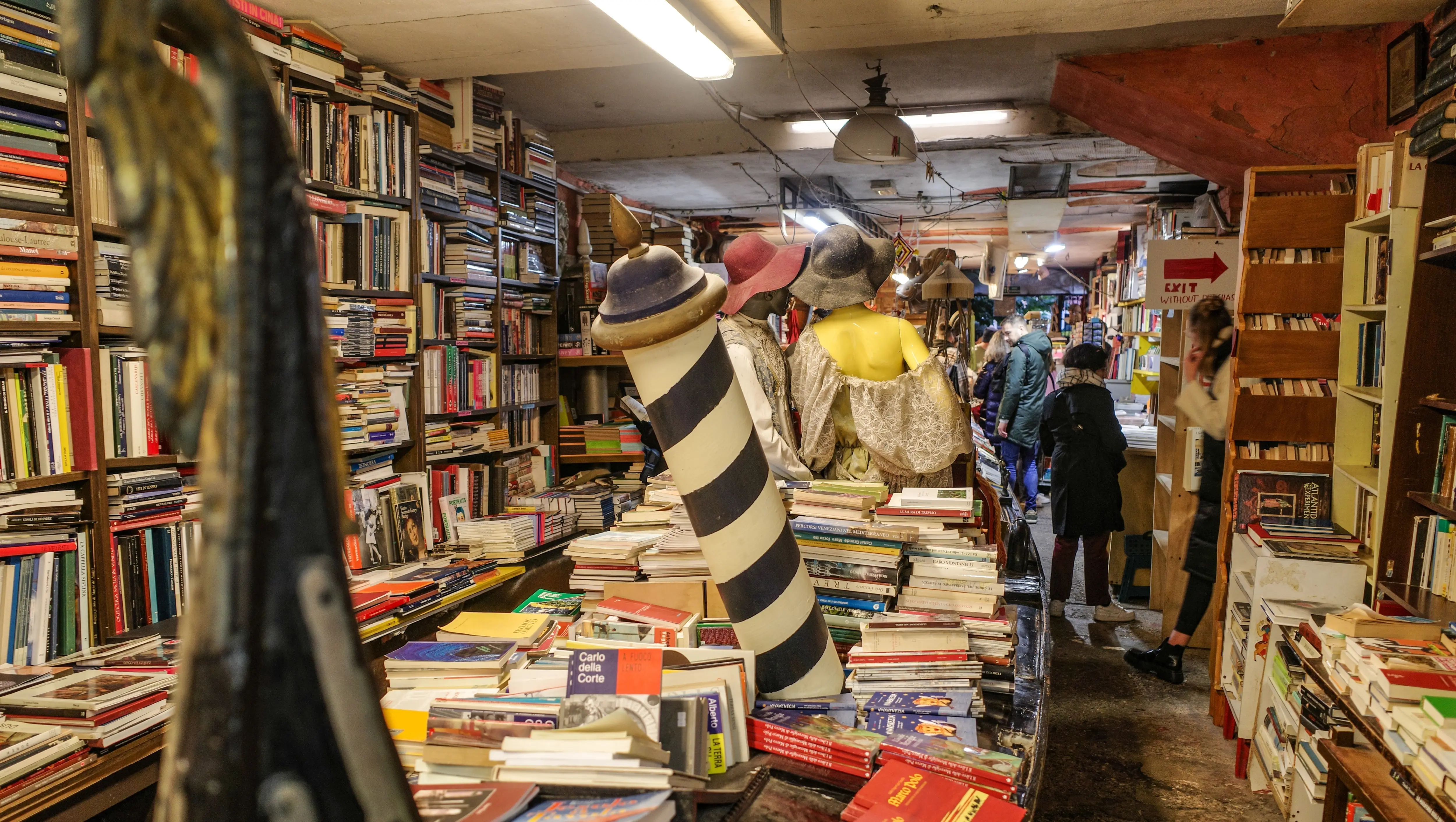 Libreria Acqua Alta Venice Italy cozy offbeat bookstore vintage titles whimsical book displays flooding resident cats