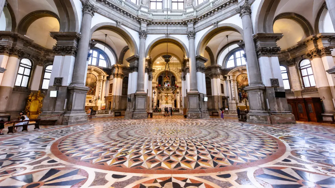 Octagonal geometric marble floor pattern Santa Maria della Salute church interior symbolizing rebirth with Baroque columns Venice Italy