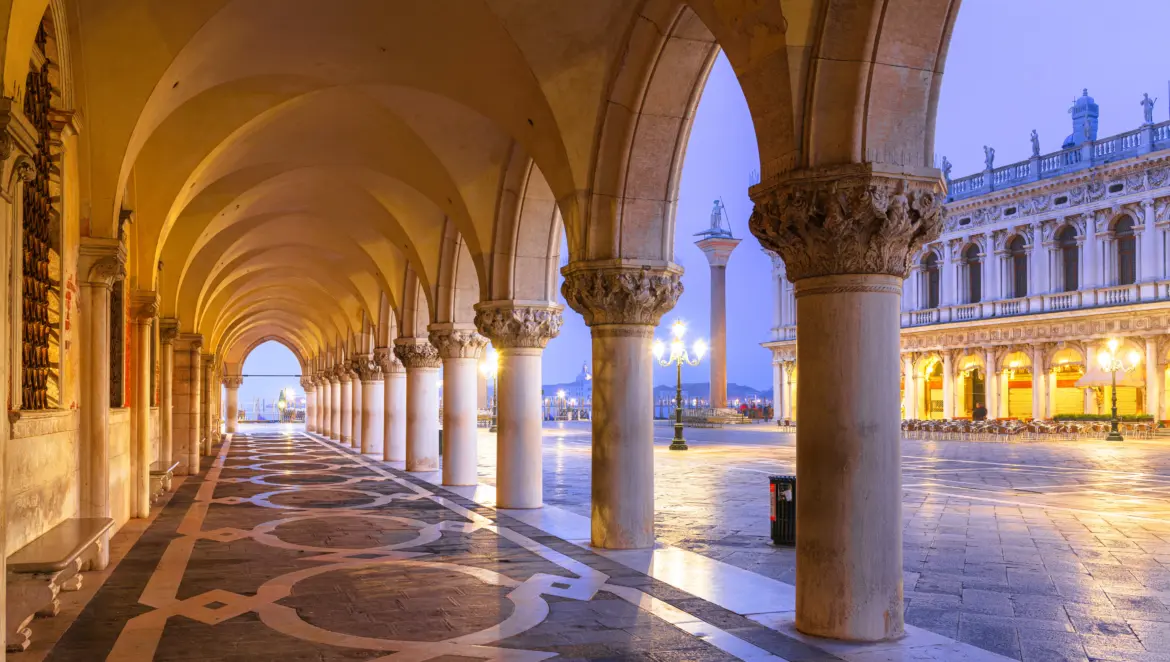 Early morning view Piazzetta San Marco from arcaded sidewalk Doge's Palace Venice Italy