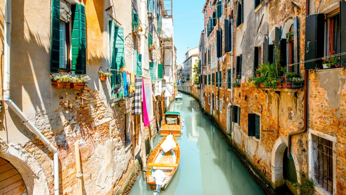 Small romantic canal Castello district Venice Italy narrow waterways historic stone buildings soft reflections authentic side away crowds