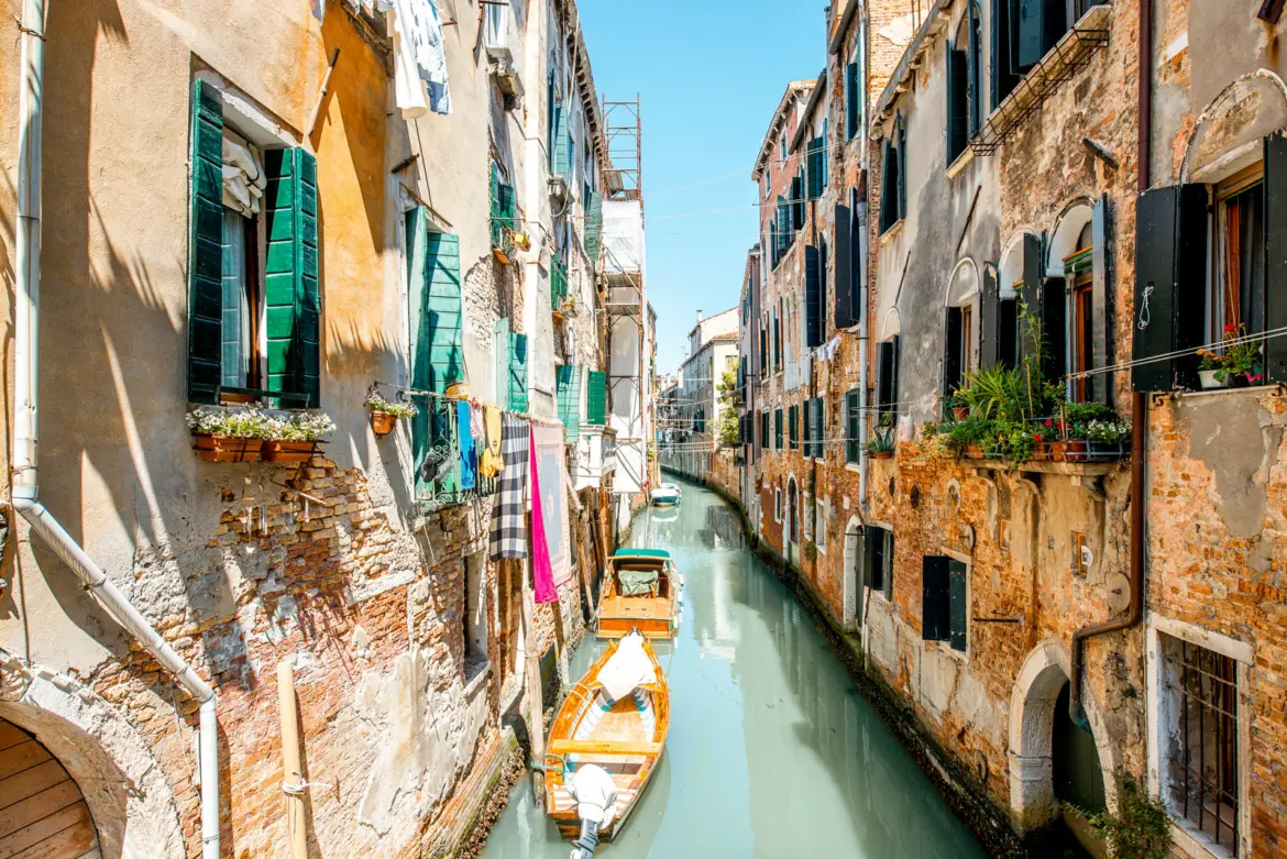 Small romantic canal Castello district Venice Italy narrow waterways historic stone buildings soft reflections authentic side away crowds