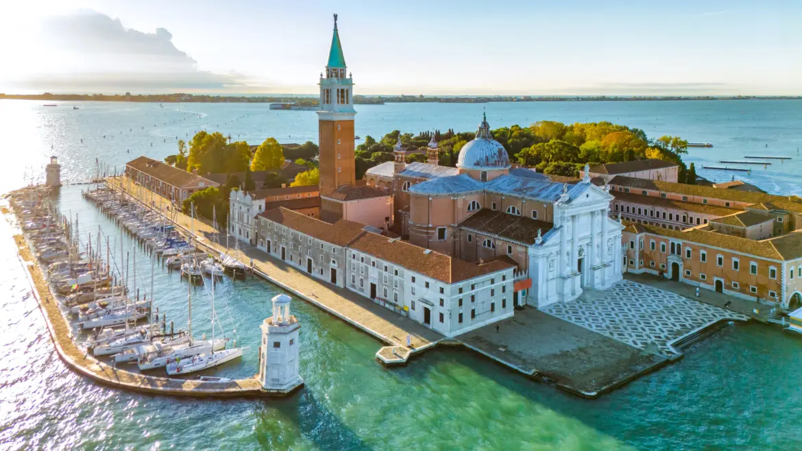 Aerial view Church San Giorgio Maggiore sunrise Venice Italy overlooking Venetian Lagoon historic Palladian church rises above calm morning waters soft light