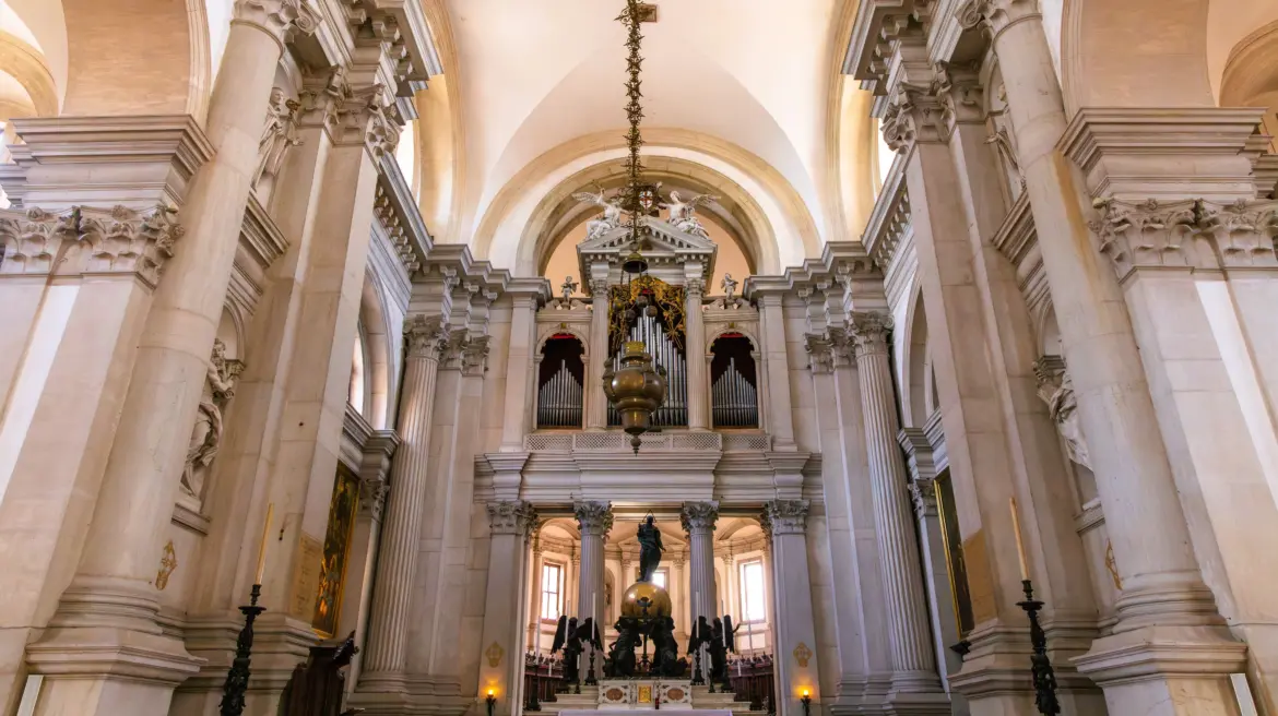 Interior Basilica San Giorgio Maggiore Venice featuring luminous high altar organ pipes Palladian architecture natural light