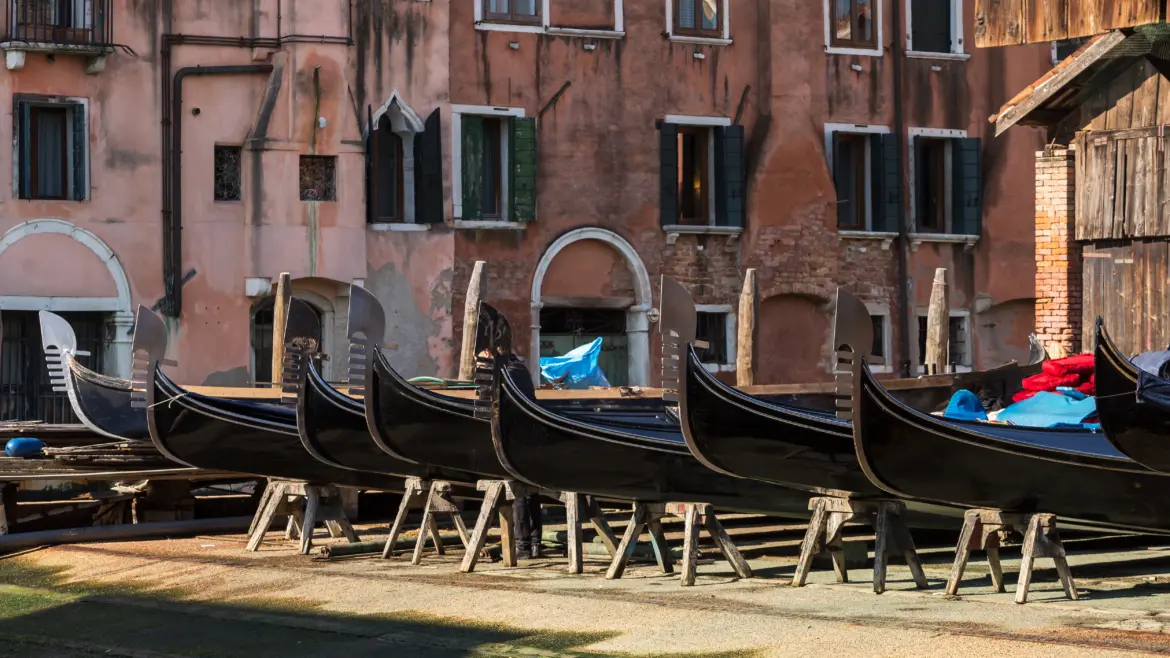 Traditional wooden gondolas lined up at Squero di San Trovaso historic gondola workshop Venice Italy