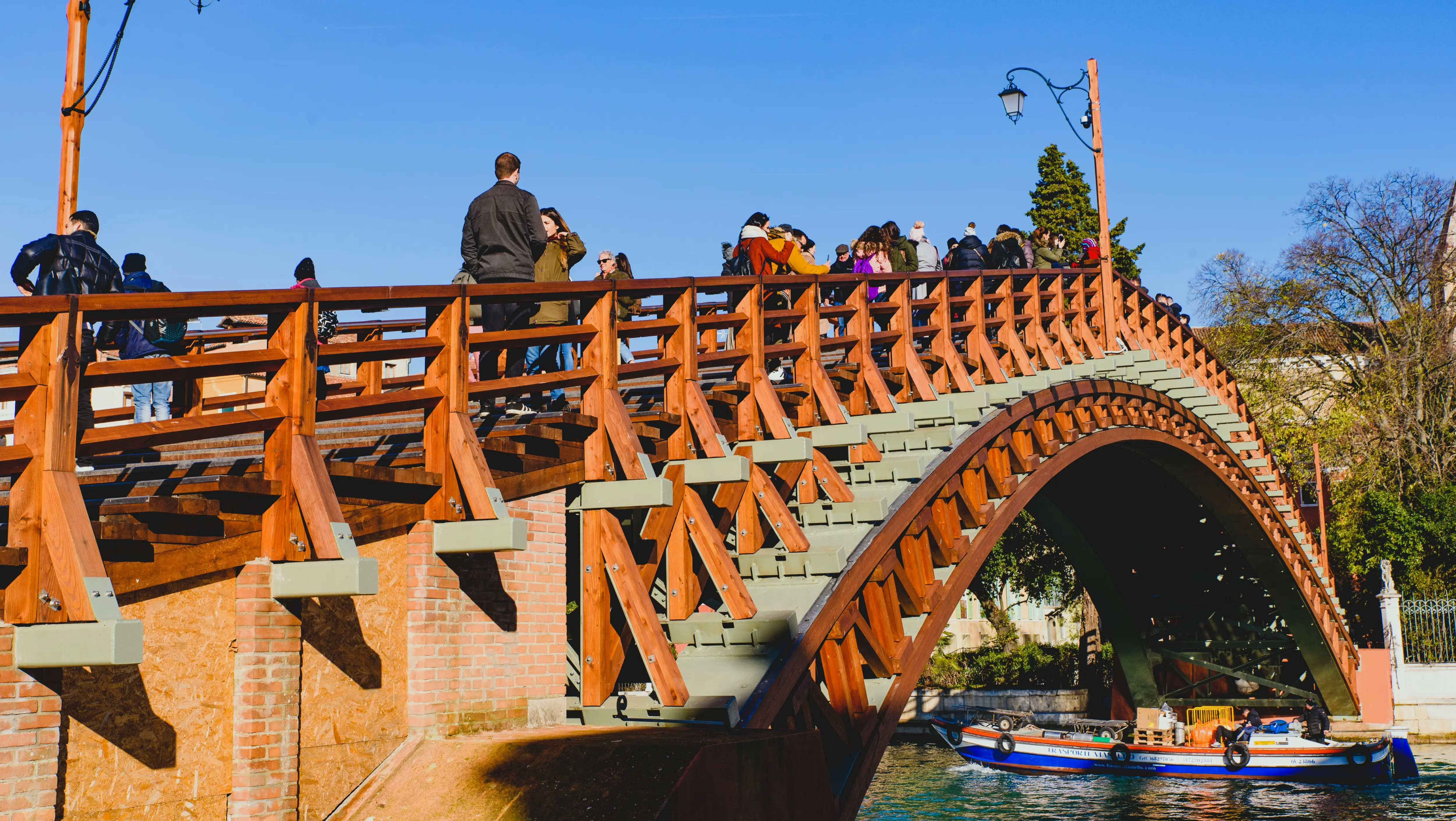 Tourists and locals crossing Ponte dell'Accademia Accademia Bridge linking Dorsoduro with San Marco Venice Italy