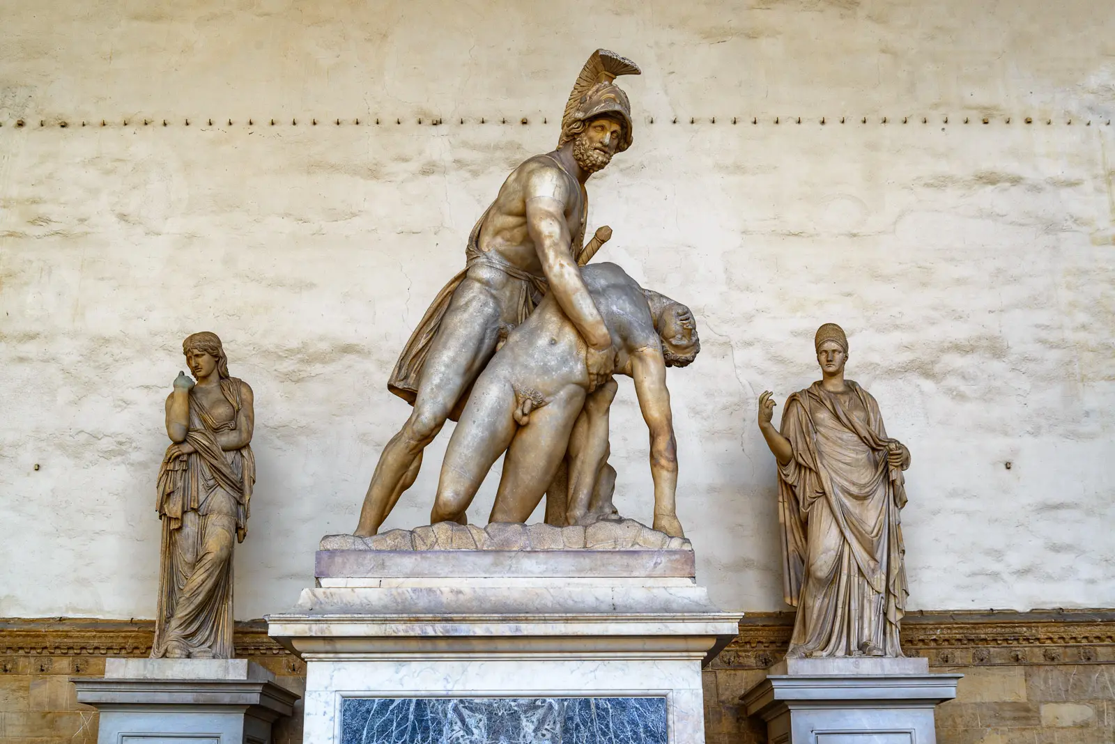 Ancient Roman sculptural group of Ajax carrying the body of Achilles at the Loggia dei Lanzi in Florence flanked by classical female statues