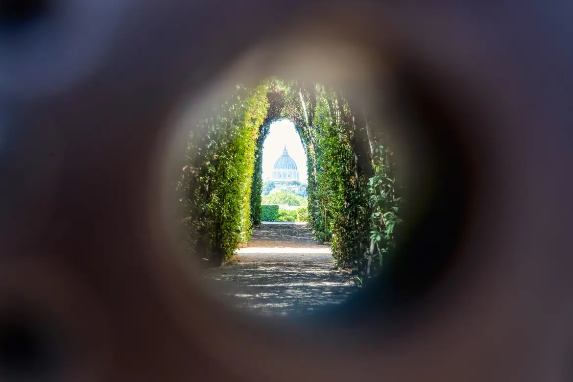 View of St Peters Basilica perfectly framed through hedgerows as seen through the Aventine Keyhole on Aventine Hill in Rome