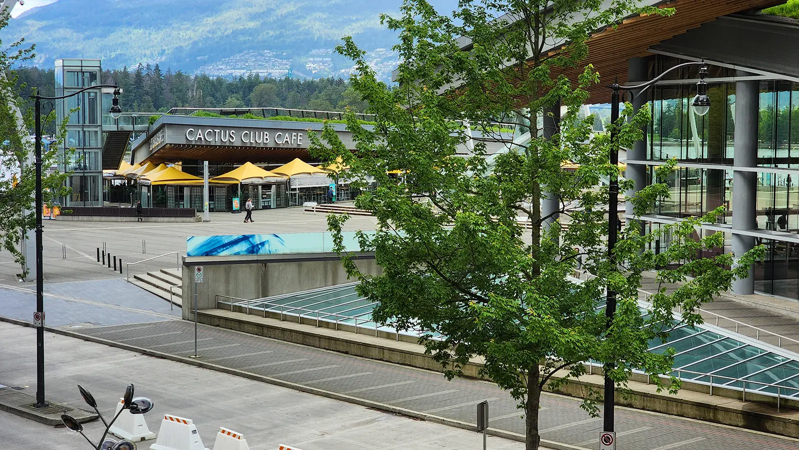 Exterior of Cactus Club Cafe at Coal Harbour in Vancouver with the waterfront and mountains in the background