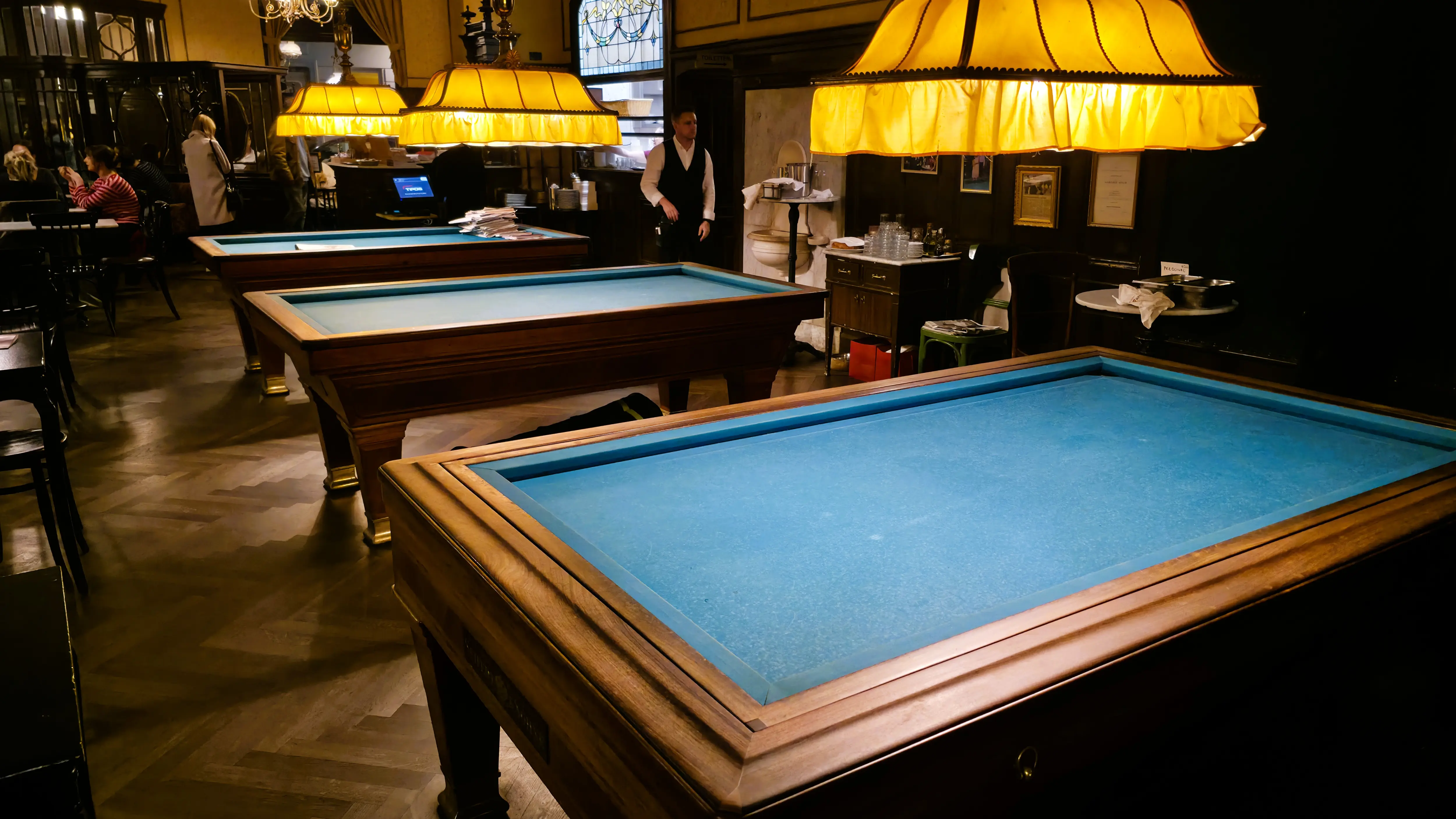 The three historic carambole billiard tables inside Café Sperl in Vienna, a rare feature of traditional Viennese coffeehouse culture