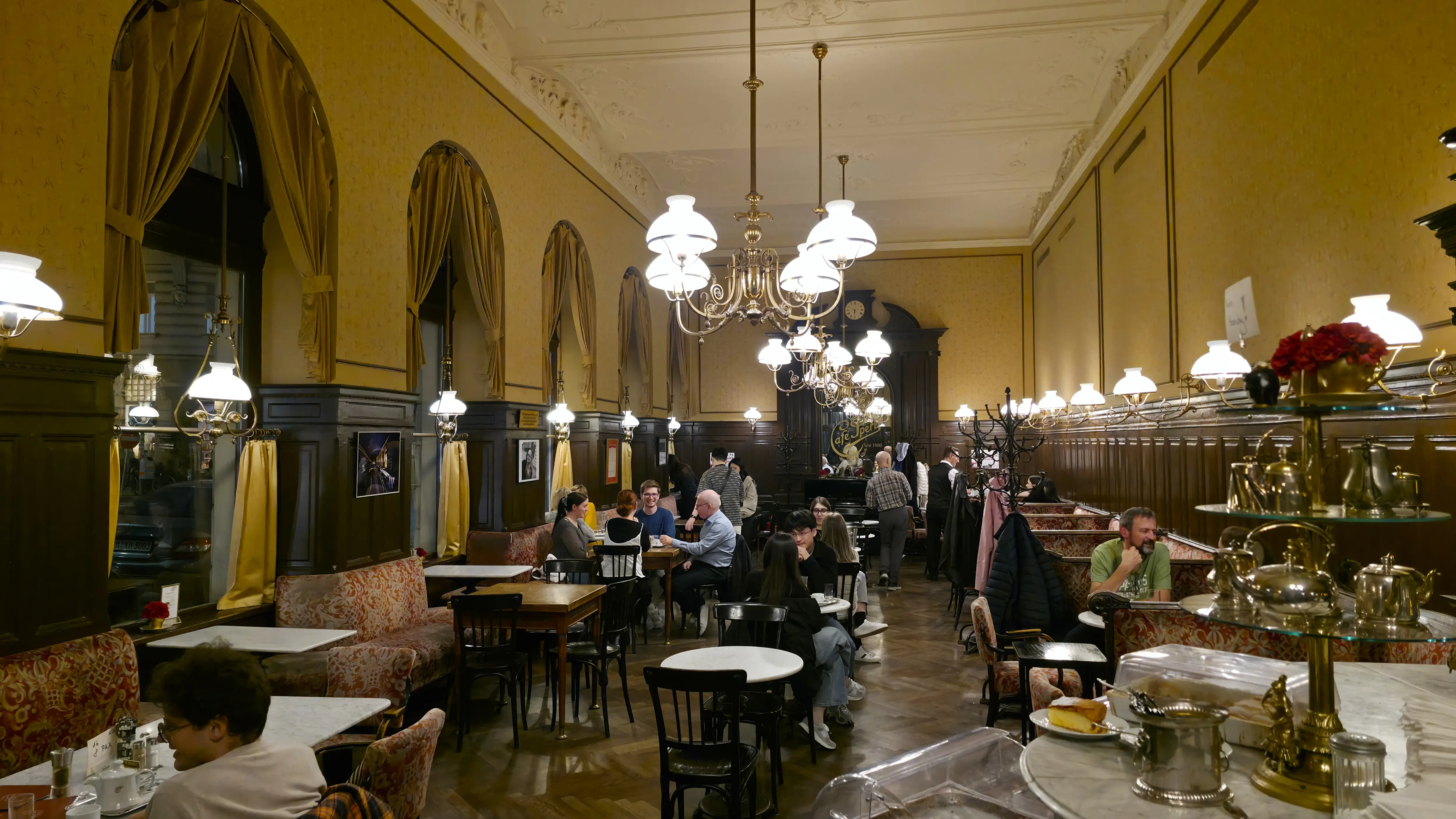 The traditional interior of Café Sperl in Vienna, with marble tables and historic atmosphere where composers and theatre figures once gathered