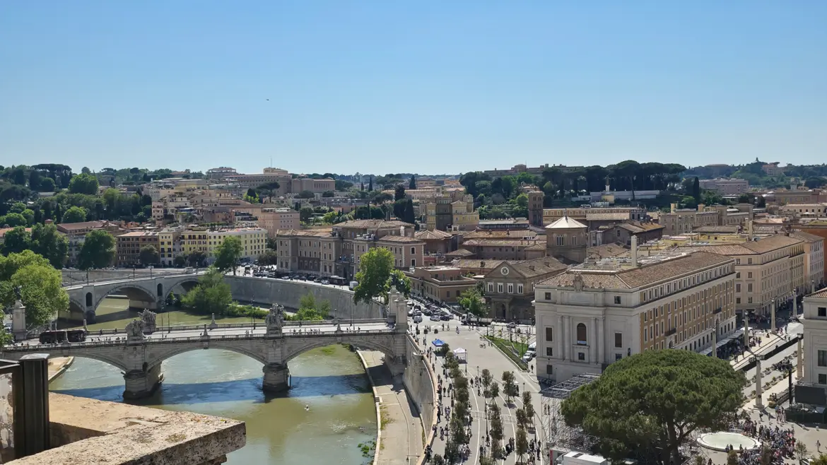 Panoramic view from the rooftop of Castel Sant Angelo in Rome overlooking the Tiber River bridges and the city skyline on a clear day