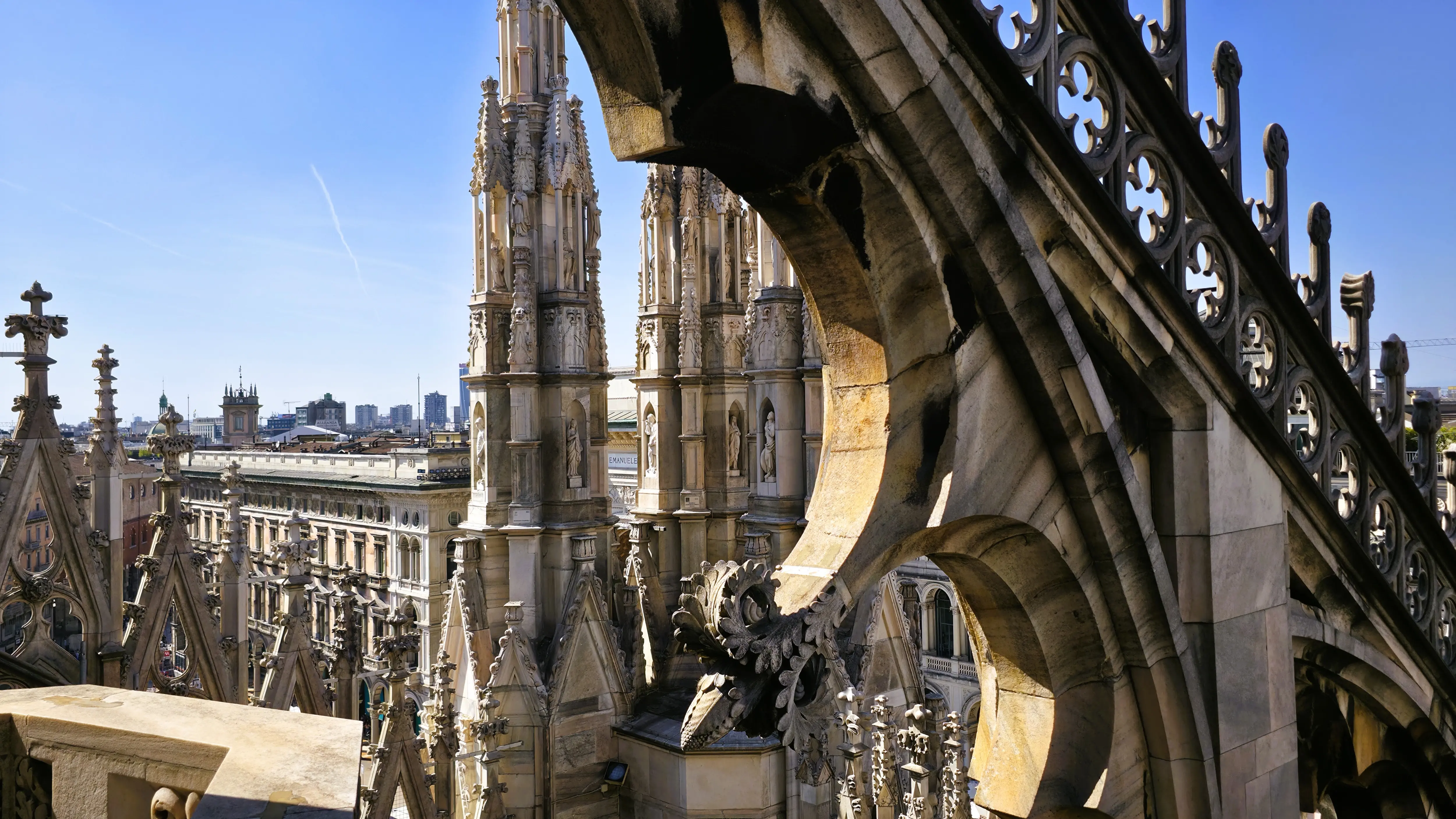 Rooftop terrace of the Duomo di Milano in Milan, Italy, showcasing intricate marble spires and Gothic architecture