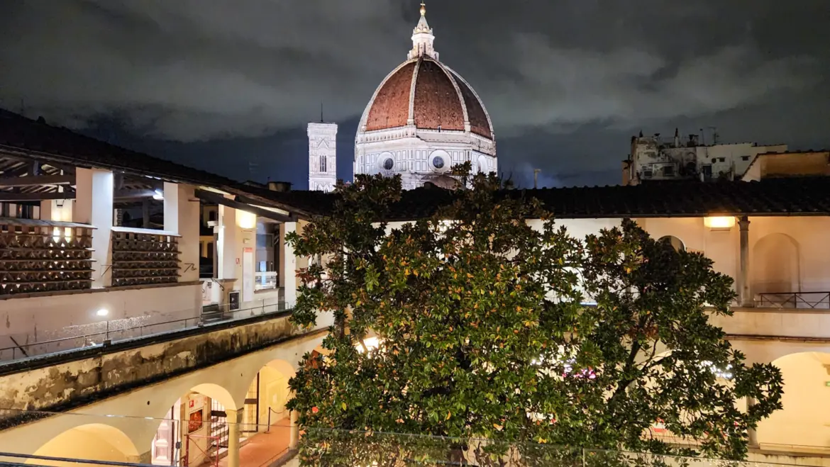 View of Brunelleschi Dome and Giotto Bell Tower at night from Caffetteria delle Oblate rooftop in Florence