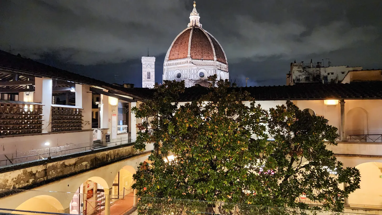 View of Brunelleschi Dome and Giotto Bell Tower at night from Caffetteria delle Oblate rooftop in Florence