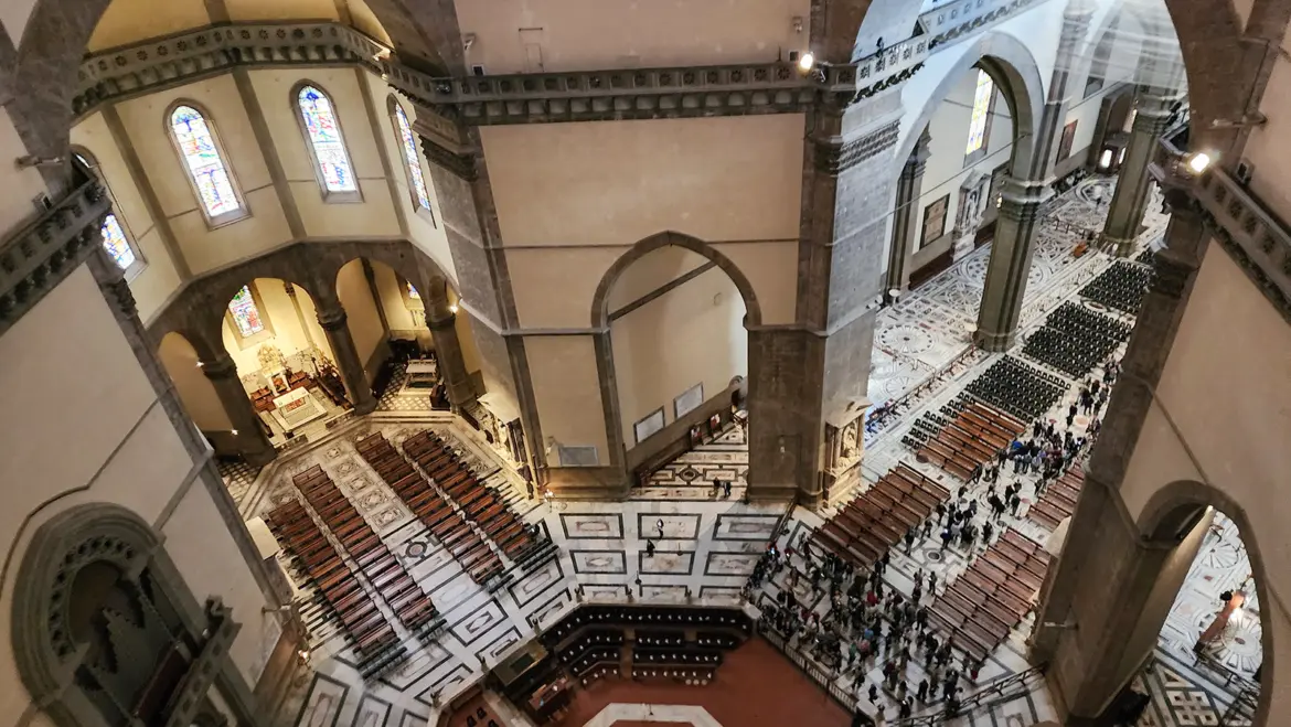 Interior view of Florence Cathedral Santa Maria del Fiore highlighting monumental Gothic architecture soaring vaults and impressive spatial scale beneath Brunelleschi’s iconic dome