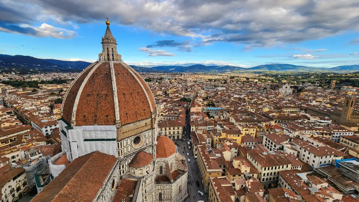 Panoramic view of Florence from the top of Giotto’s Campanile featuring Brunelleschi’s dome terracotta rooftops and the sweeping Renaissance skyline