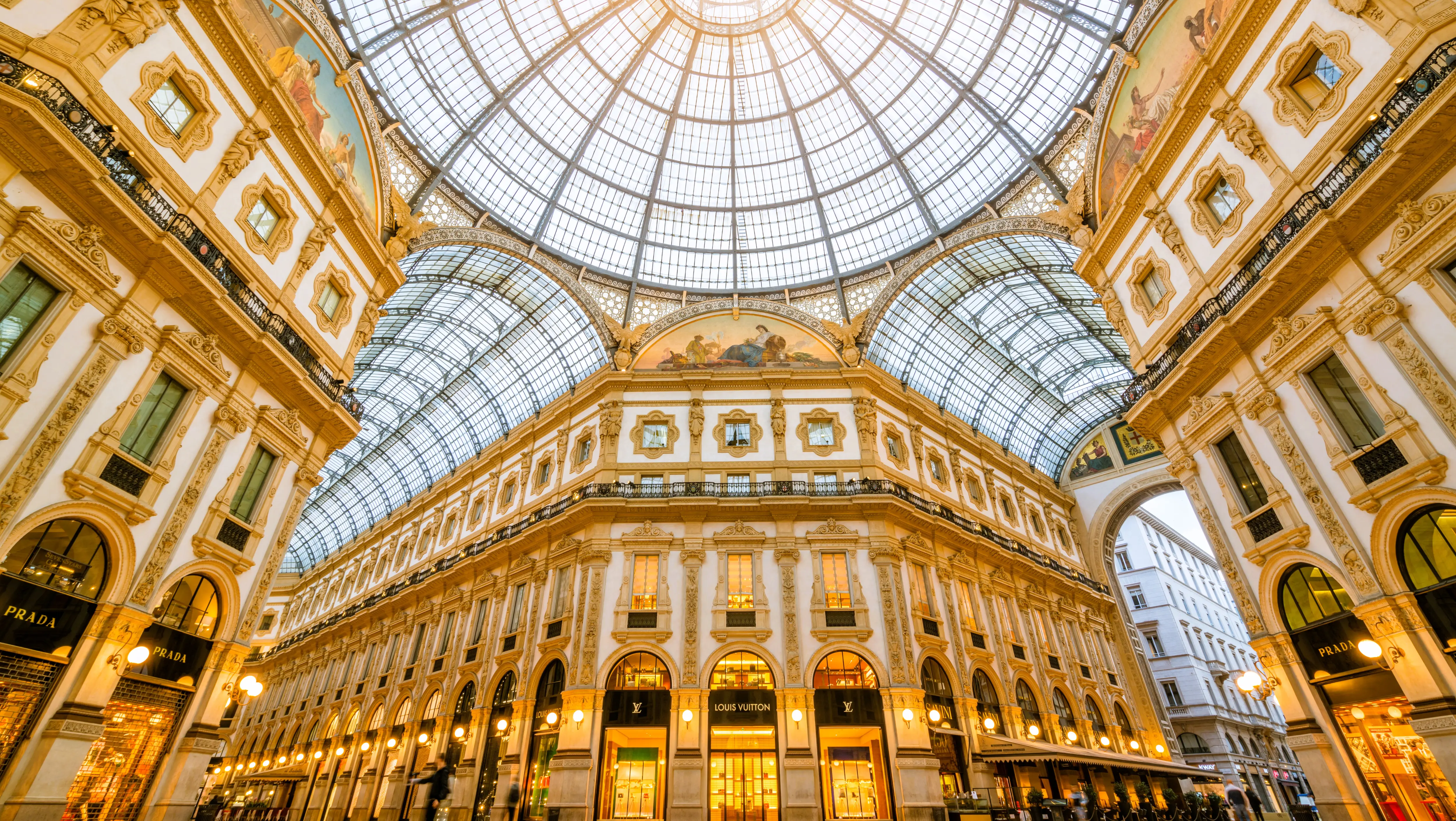Interior of the Galleria Vittorio Emanuele II in Milan, Italy, showcasing its glass dome and ornate 19th-century architecture