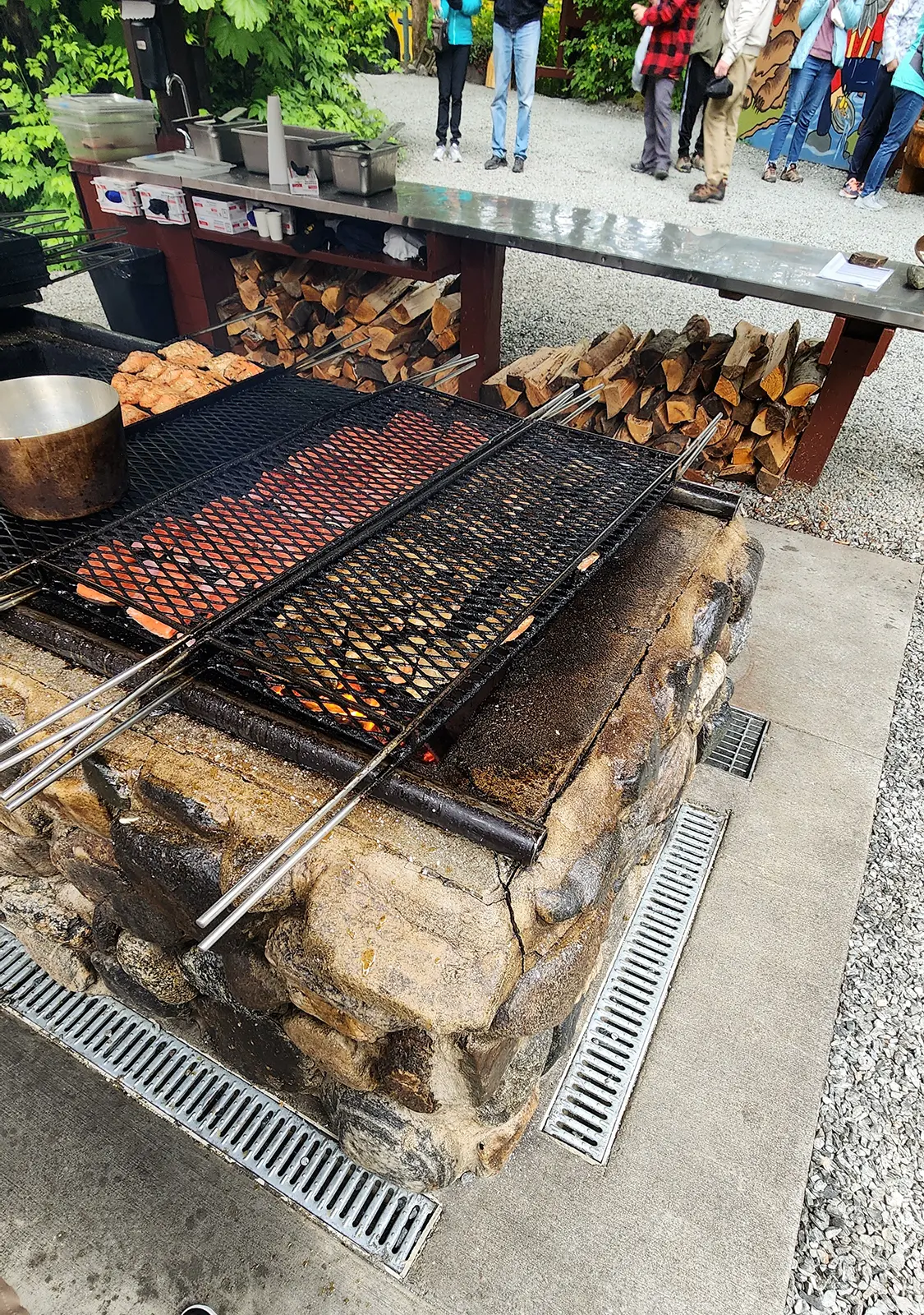 Wild Alaskan salmon and ribs grilling over an open alder wood fire at the Gold Creek Salmon Bake in Juneau