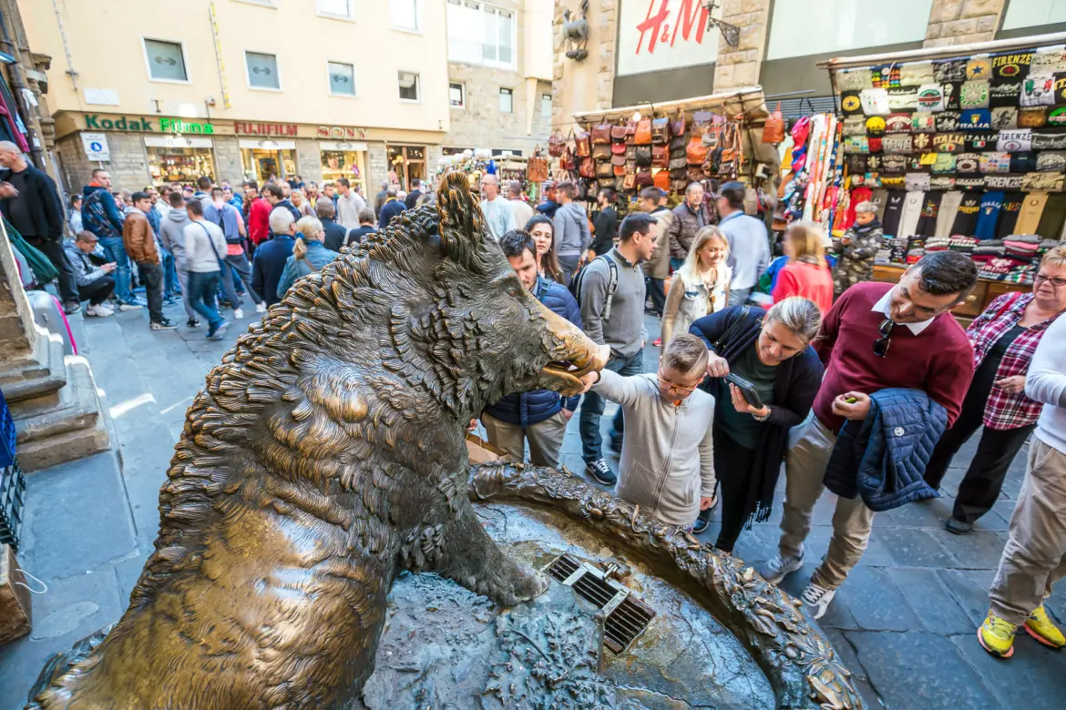 Visitors gathered around Il Porcellino at Mercato Nuovo in Florence rubbing the bronze boar’s nose for good luck, a tradition dating back centuries