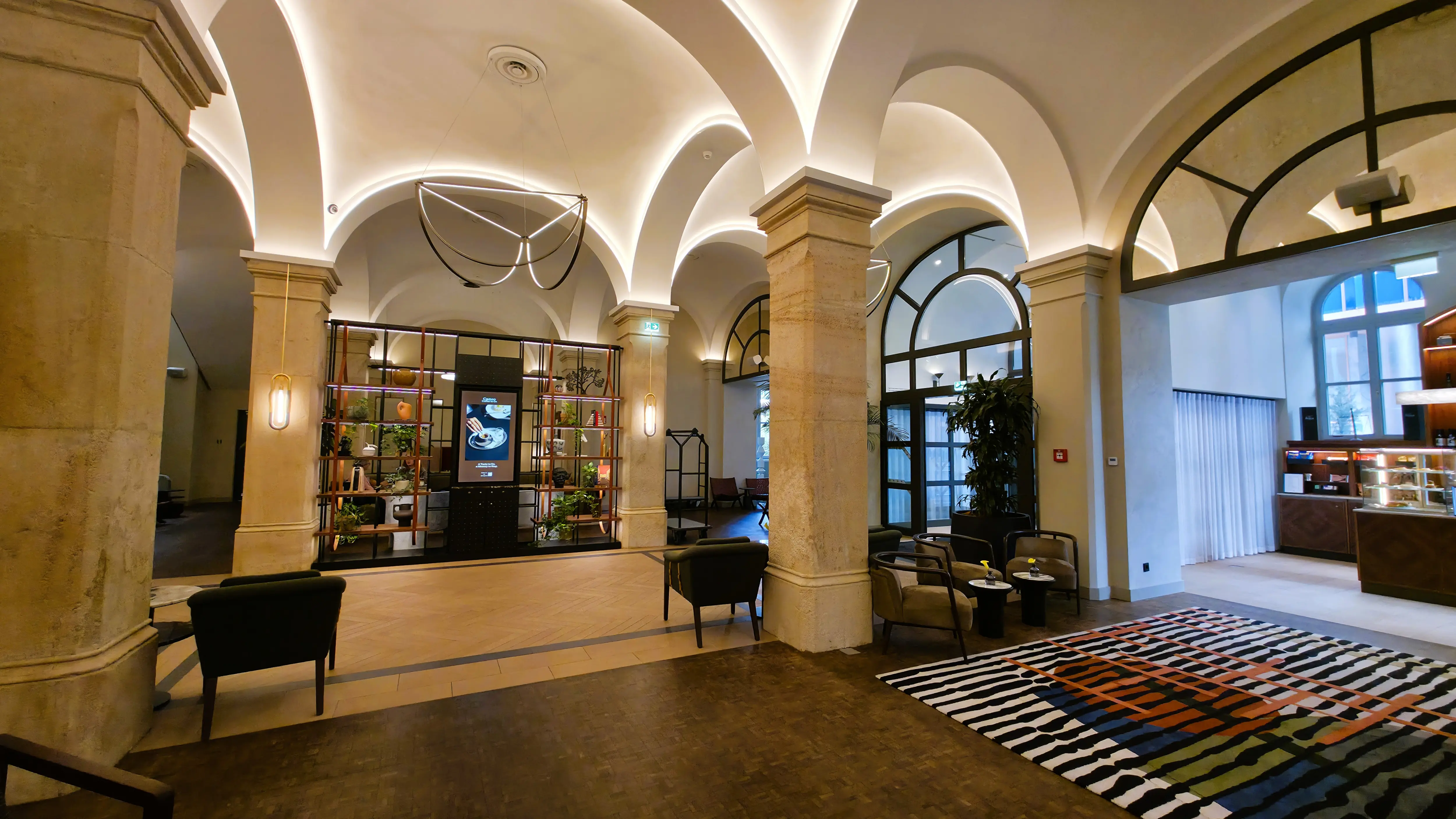 Interior detail at the Imperial Riding School in Vienna, showing subtle equestrian references and layered lighting reflecting the building’s historic origins