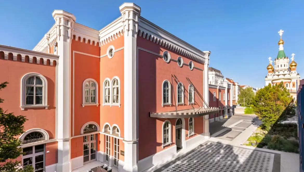 Exterior of the Imperial Riding School, Autograph Collection in Vienna, with the domes of the Russian Orthodox Cathedral of St. Nicholas in the background