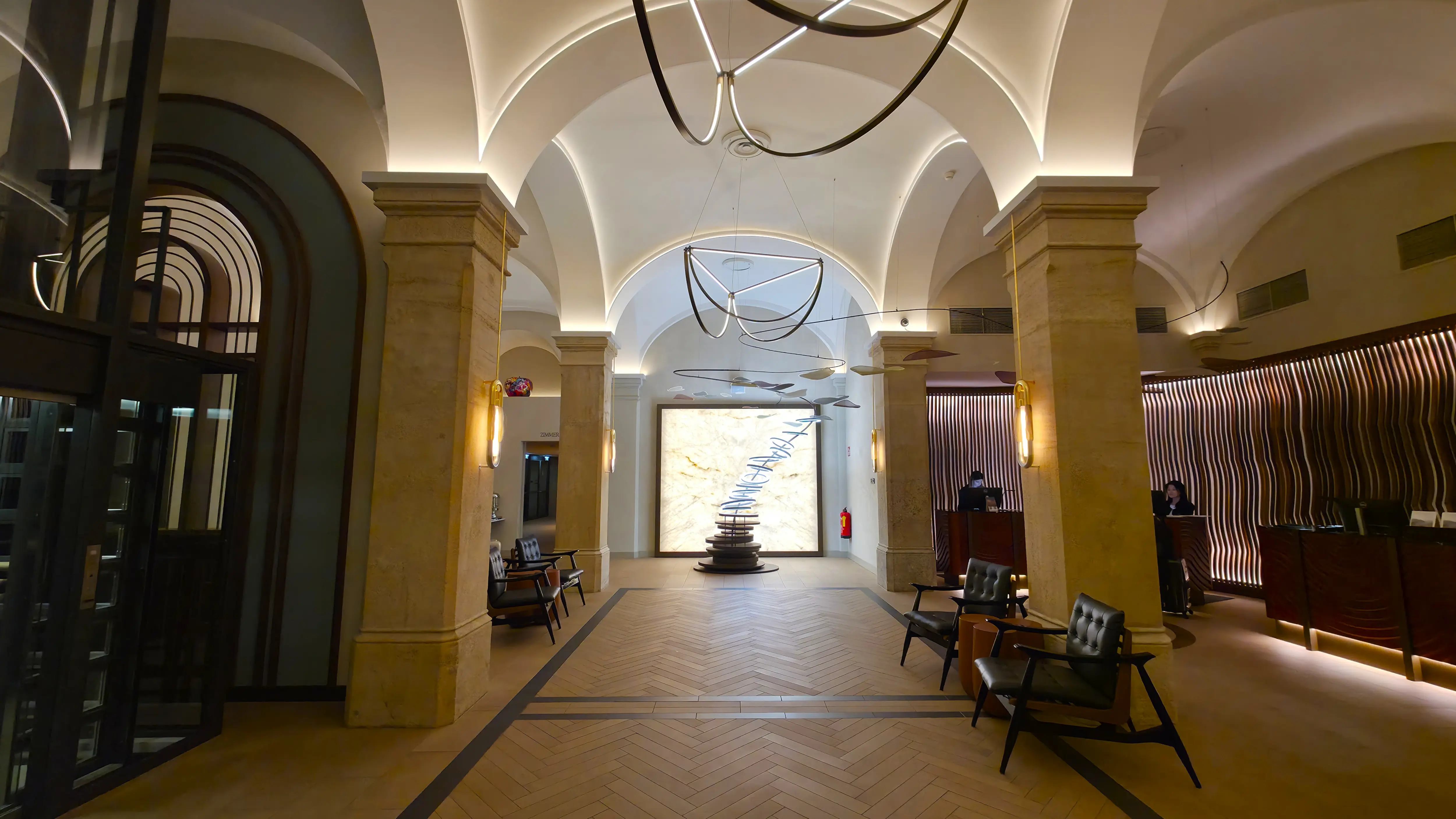 The lobby and reception area of the Imperial Riding School, Autograph Collection in Vienna, where historic elements meet contemporary design
