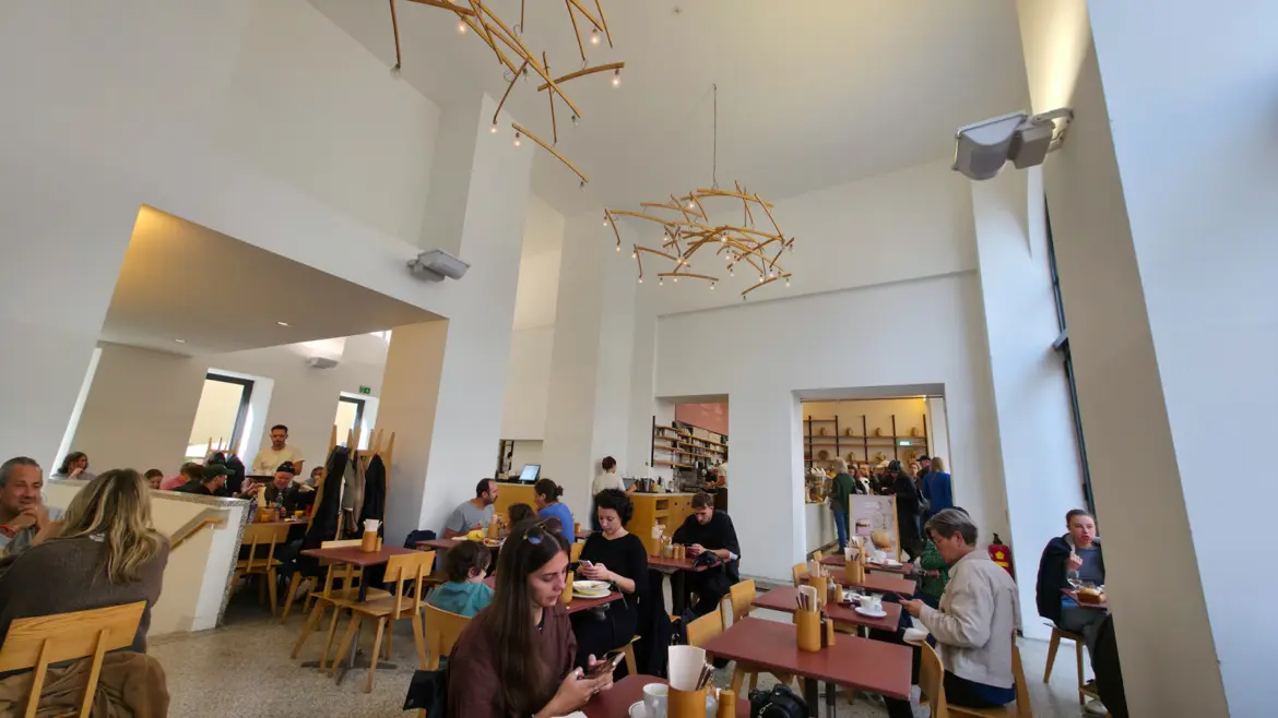 Contemporary café seating inside Joseph Brot in Vienna offering organic breakfast and specialty coffee