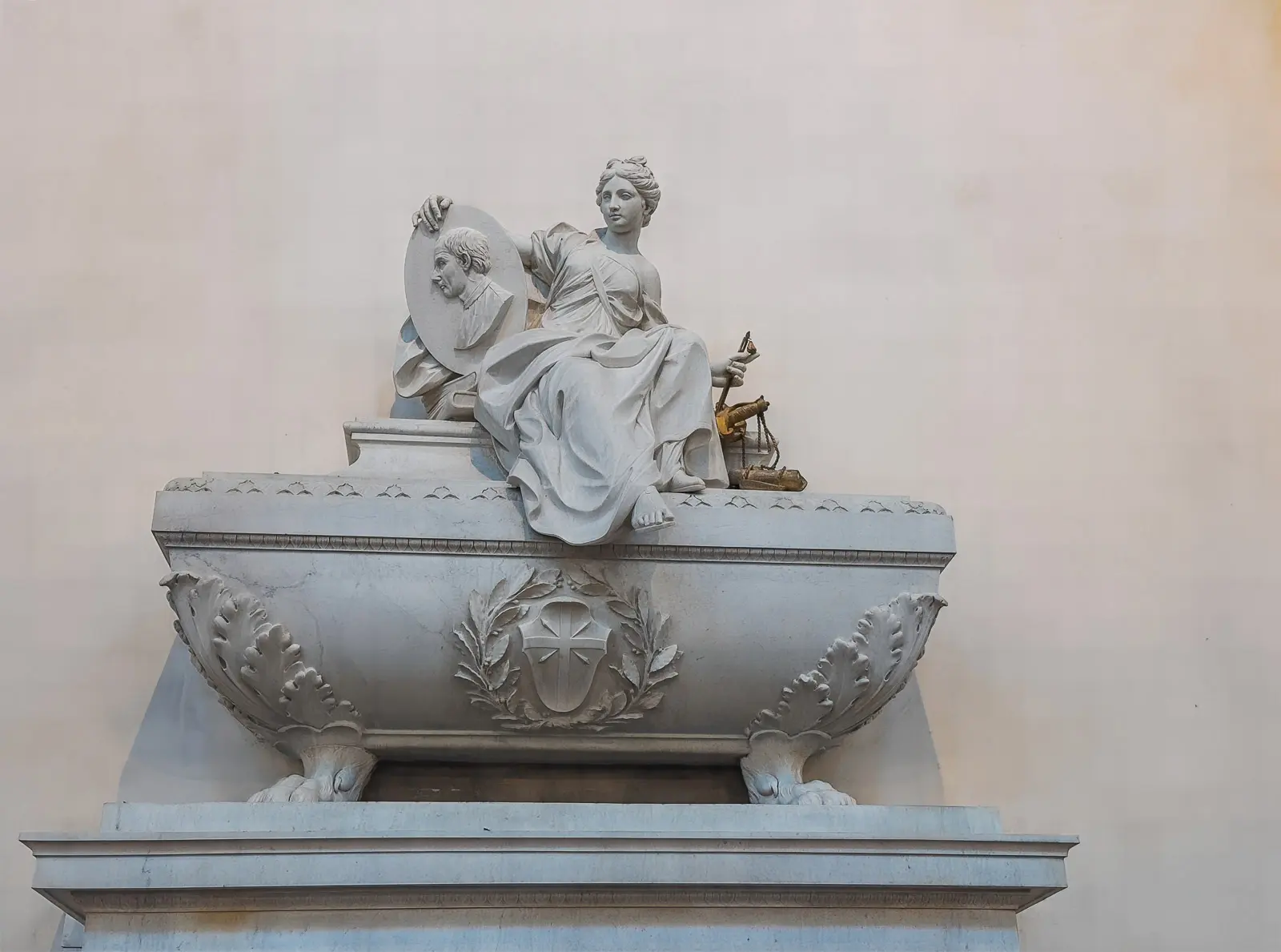 Tomb of Niccolo Machiavelli inside Santa Croce Basilica in Florence with allegorical figure of Diplomacy seated on the marble sarcophagus