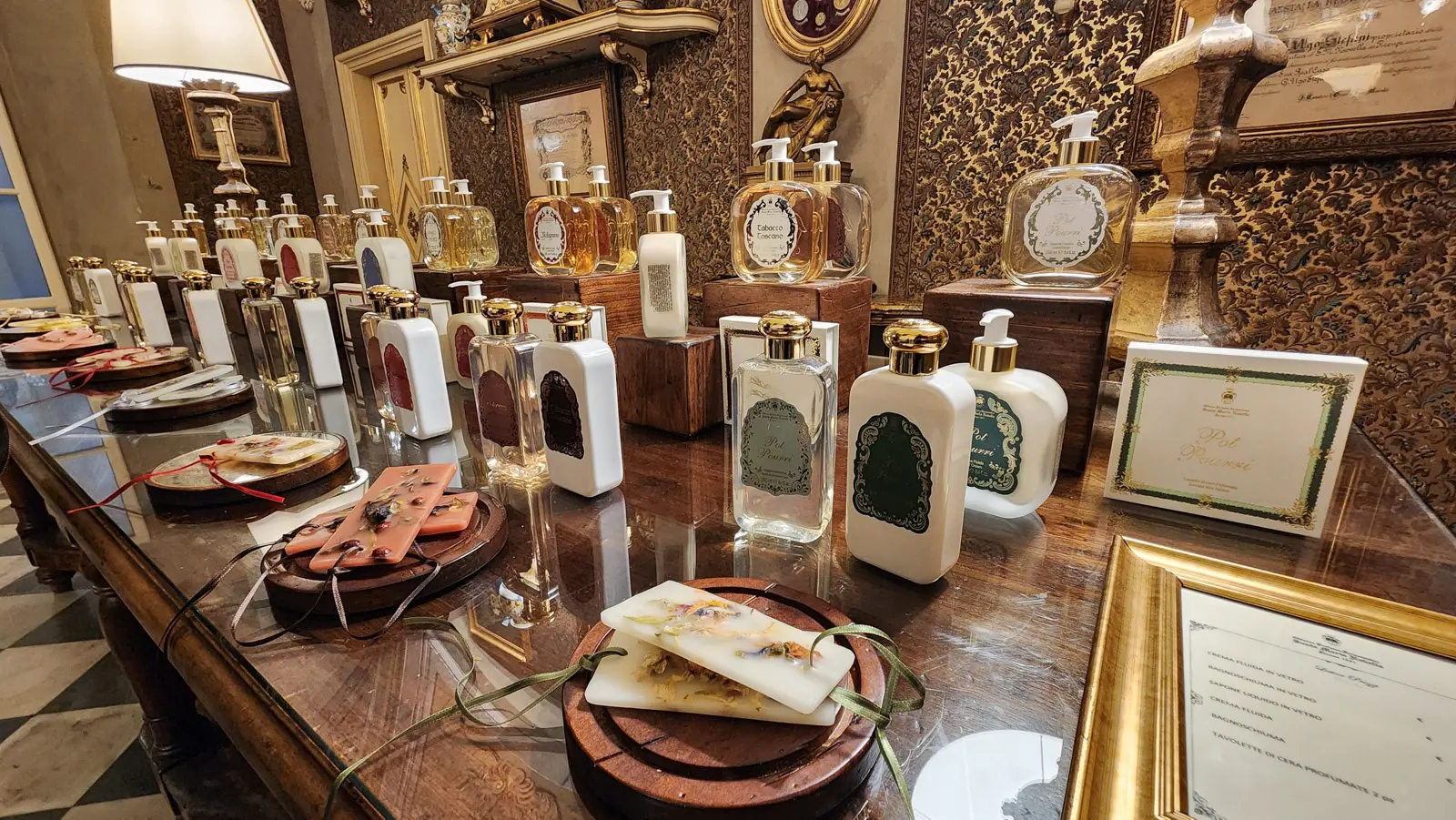 Display of artisanal perfumes soaps and lotions inside the Officina Profumo-Farmaceutica di Santa Maria Novella historic perfumery in Florence
