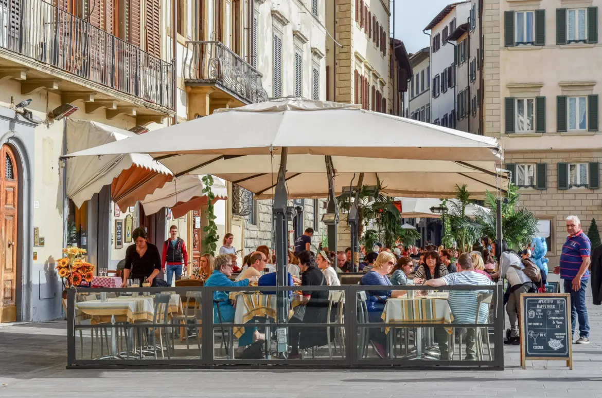 People enjoying coffee at an outdoor café in Florence, Italy
