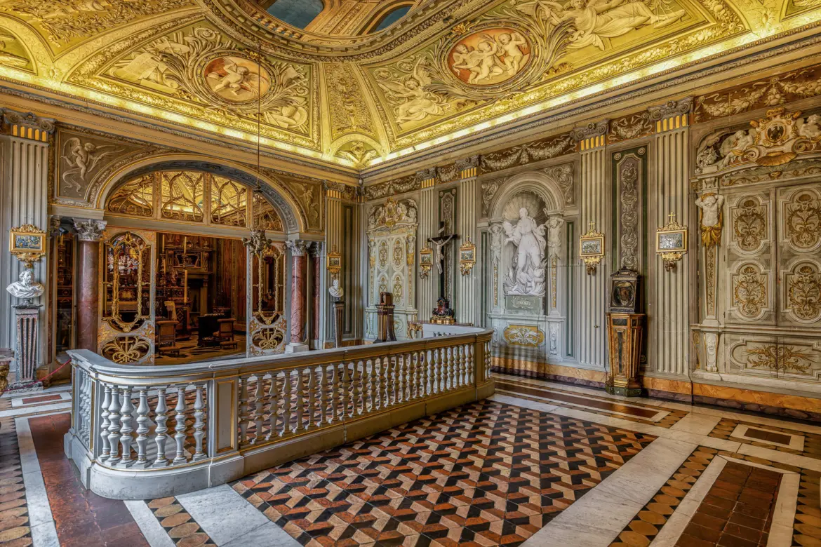Ornate gilded interior of Palazzo Doria Pamphilj private gallery in Rome with marble floor frescoed ceiling and Baroque decorative details