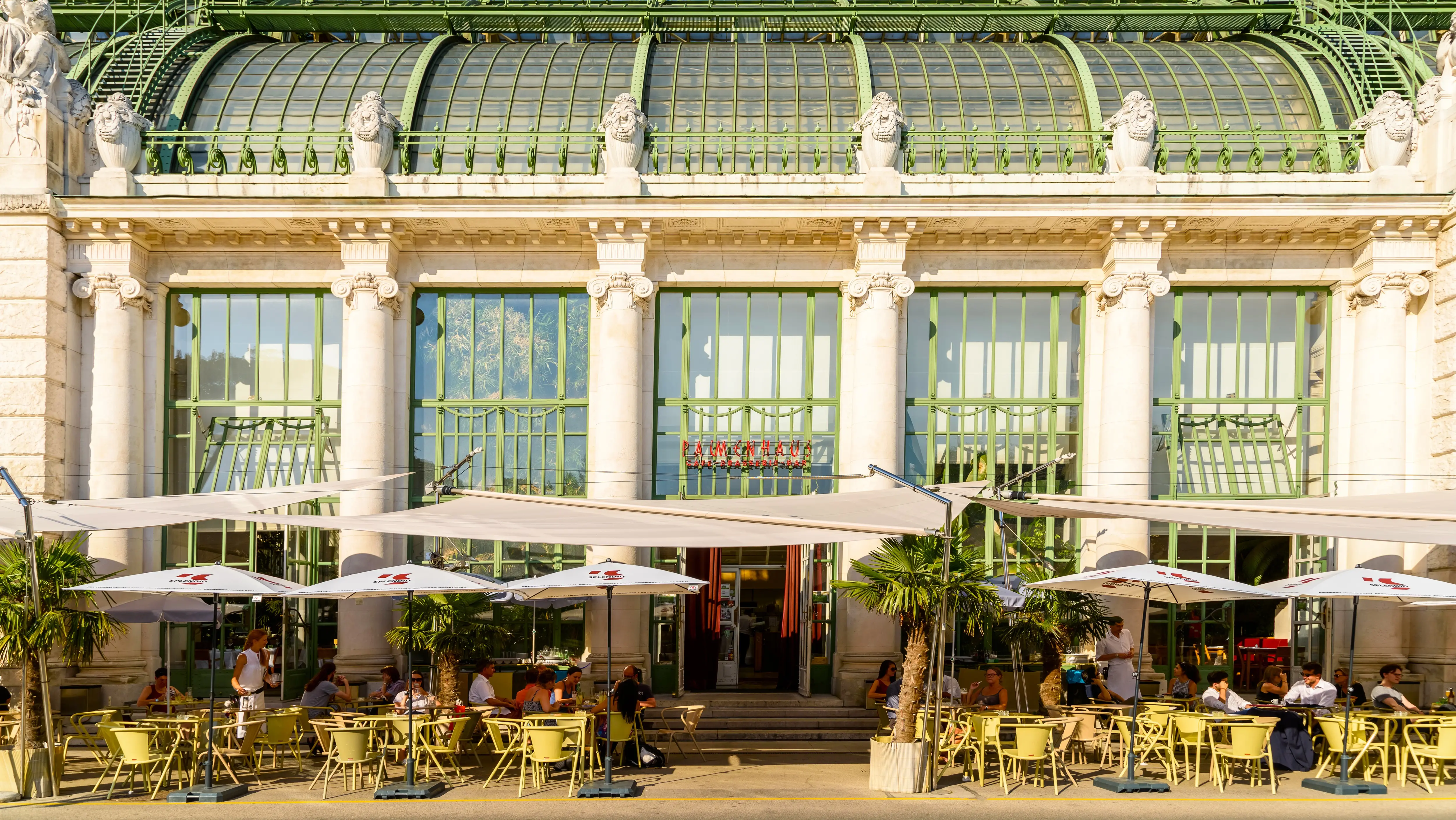 Café seating in front of the Palmenhaus in Burggarten, Vienna, a beautiful spot to relax and admire the garden