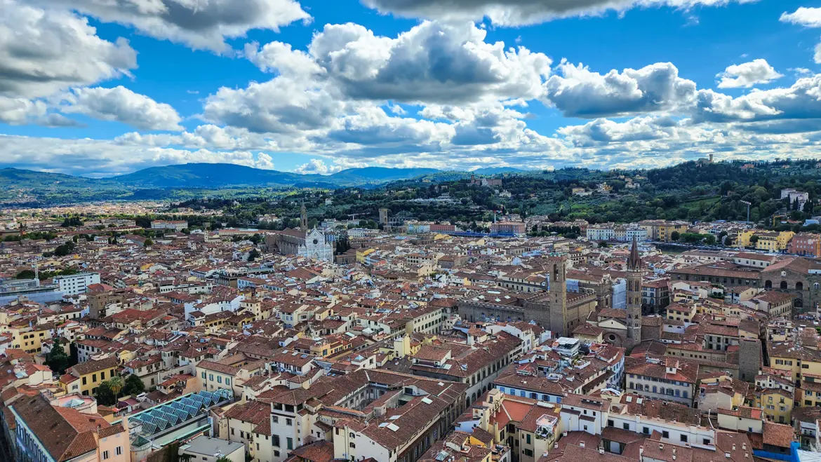 Panoramic view over Florence from the top of Brunelleschi’s dome at the Duomo revealing terracotta rooftops Santa Croce and sweeping views across the historic Renaissance city