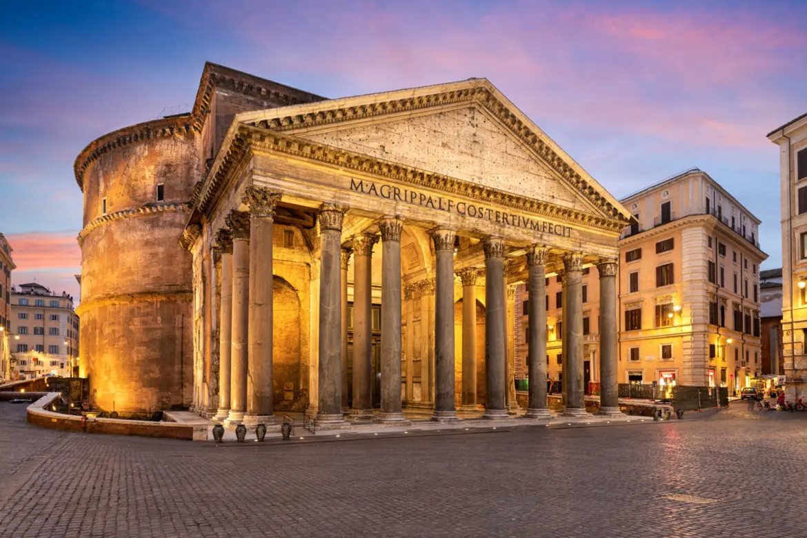 The Pantheon in Rome Italy illuminated at night showing the ancient portico with Corinthian columns and Latin inscription