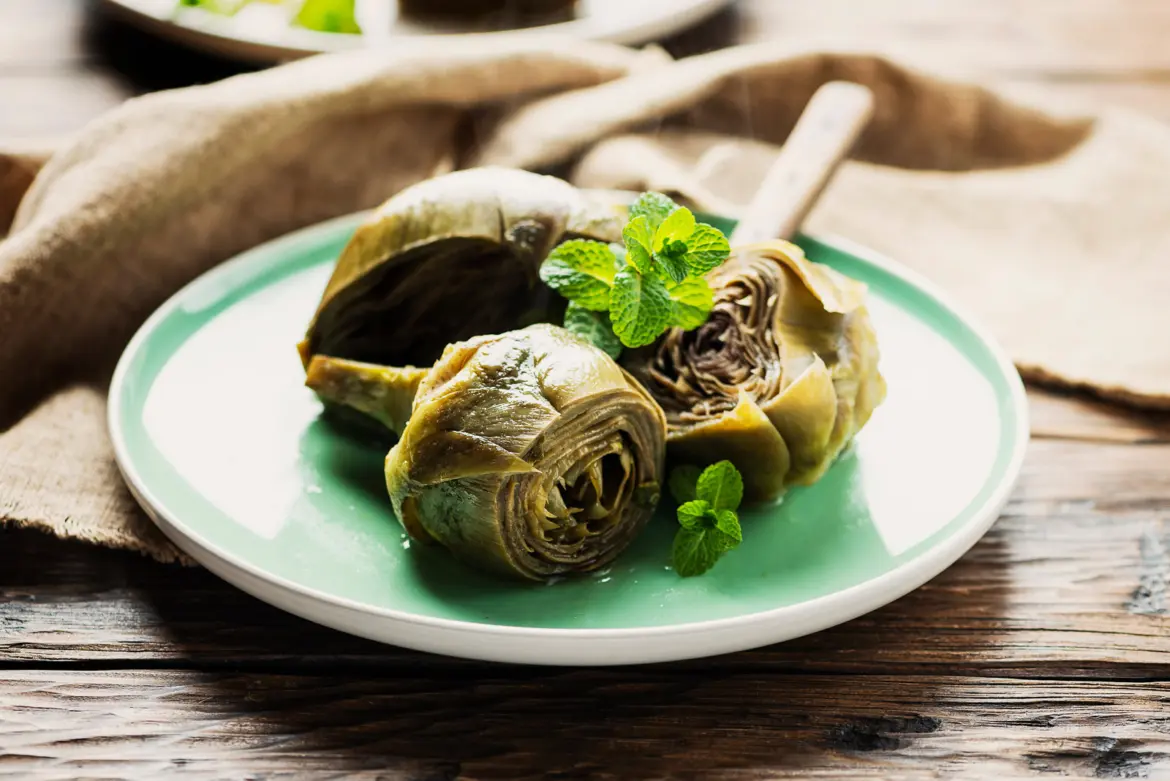 Deep-fried artichokes alla giudia traditional Roman Jewish cuisine served on a white plate in Rome