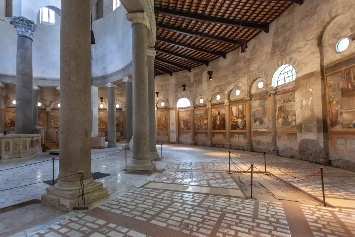 Interior of Santo Stefano Rotondo circular church in Rome with ancient columns soft light through arched windows and marble floor