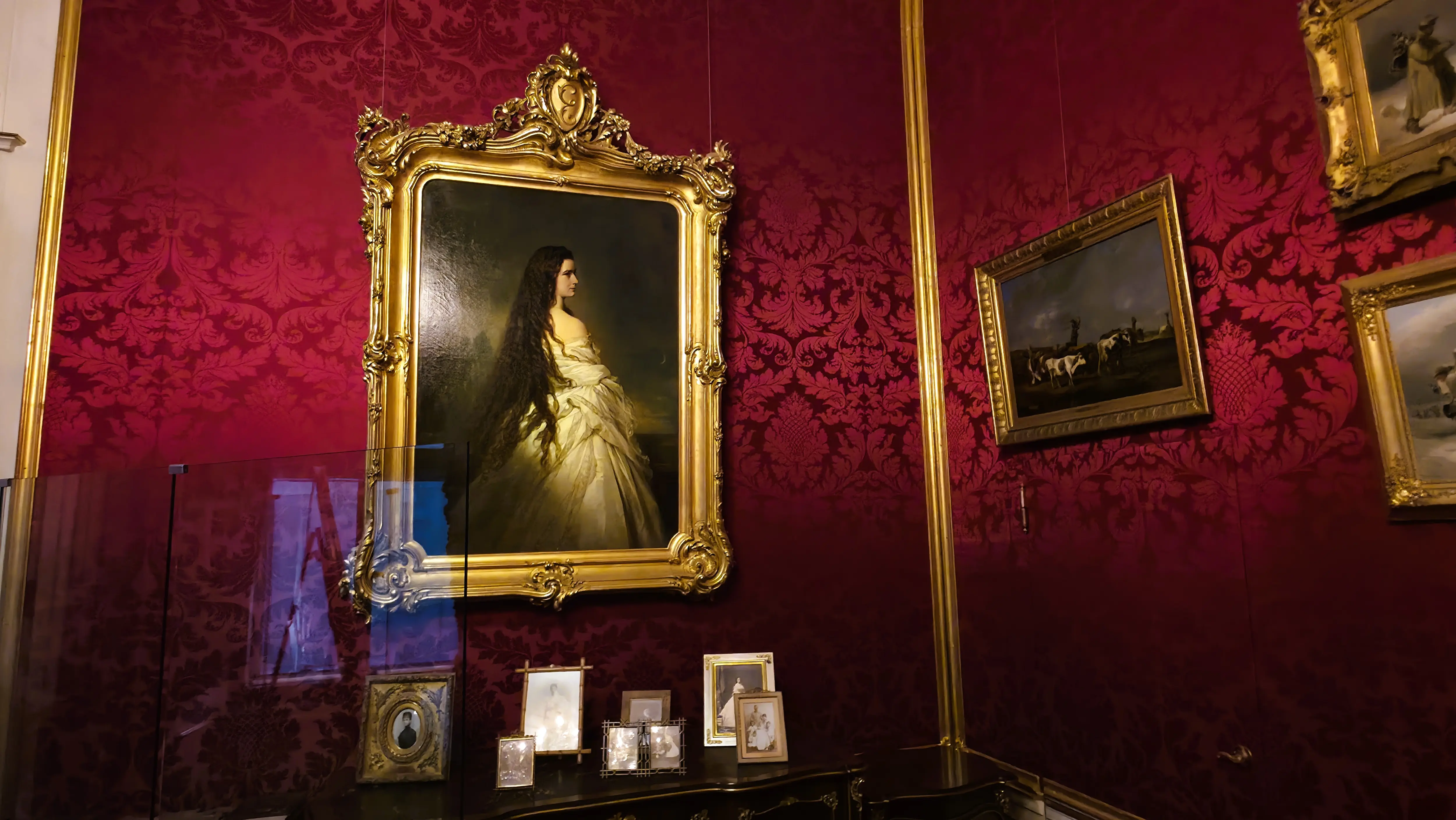 Portrait of Empress Elisabeth (Sisi) at the Sisi Museum in Vienna, displayed alongside personal family photographs