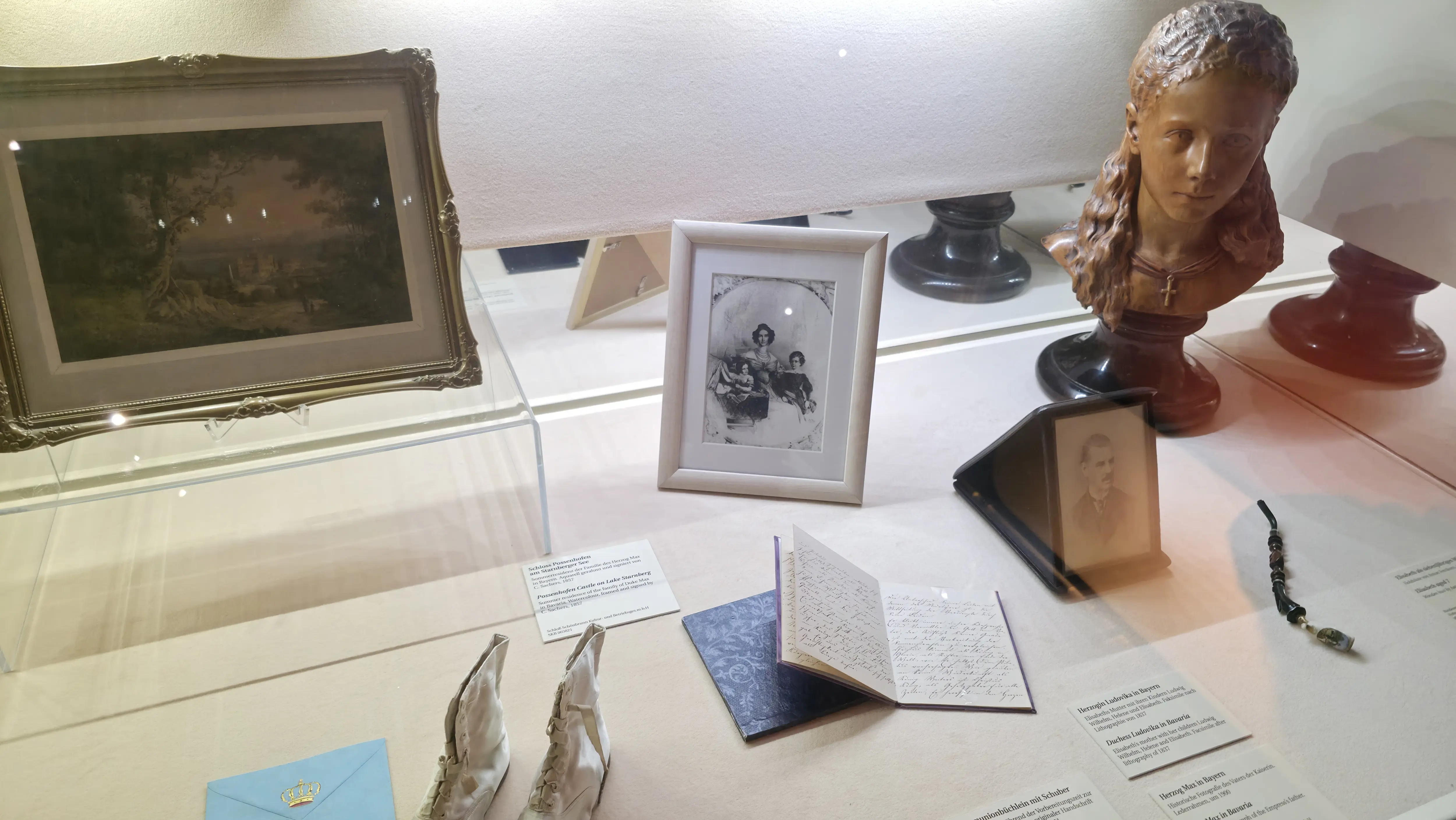 Personal items of Empress Elisabeth (Sisi) at the Sisi Museum, including family photographs and baby shoes