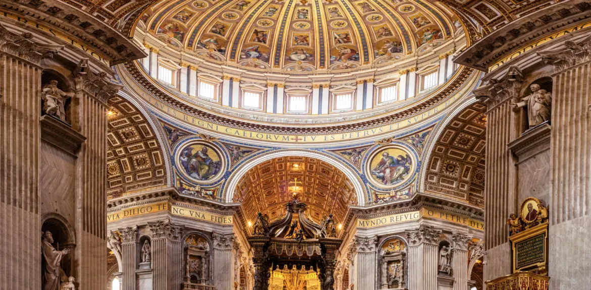 Interior of St Peter’s Basilica dome in Vatican City with ornate gold mosaics soaring architecture and Bernini’s baldachin below