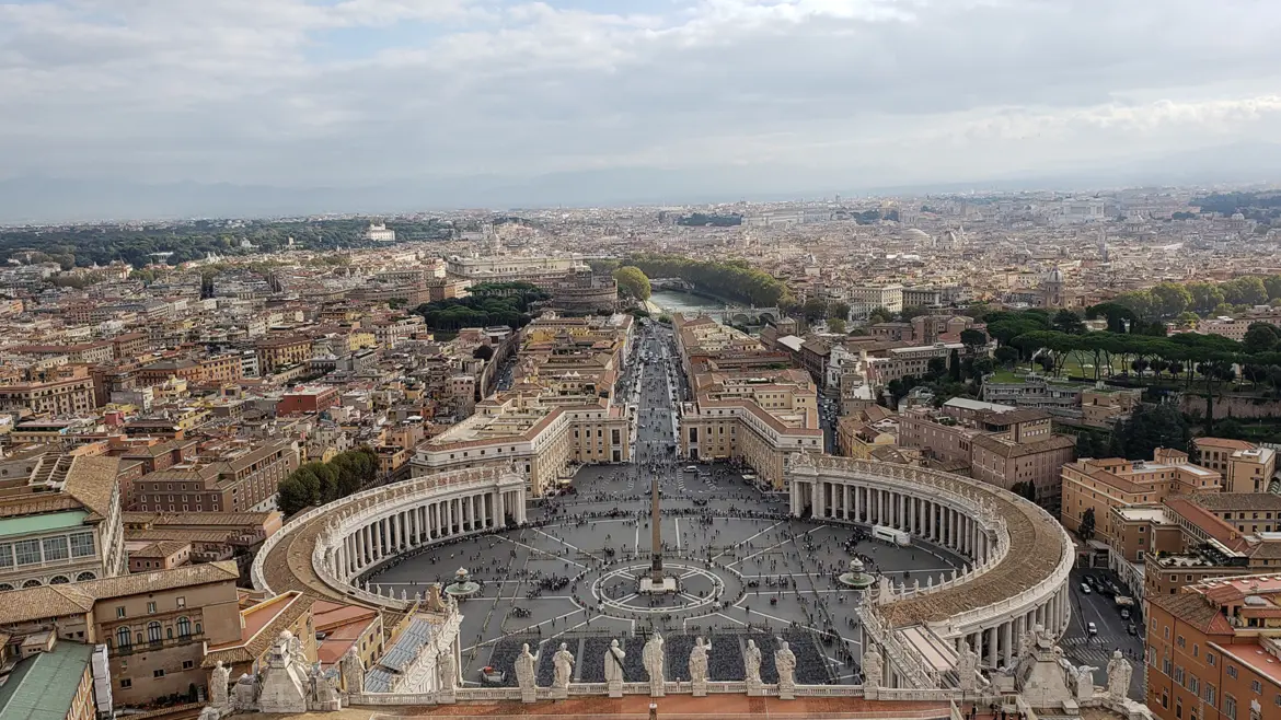 St Peter’s Square in Vatican City with Bernini’s sweeping colonnades central obelisk and the basilica façade under warm light