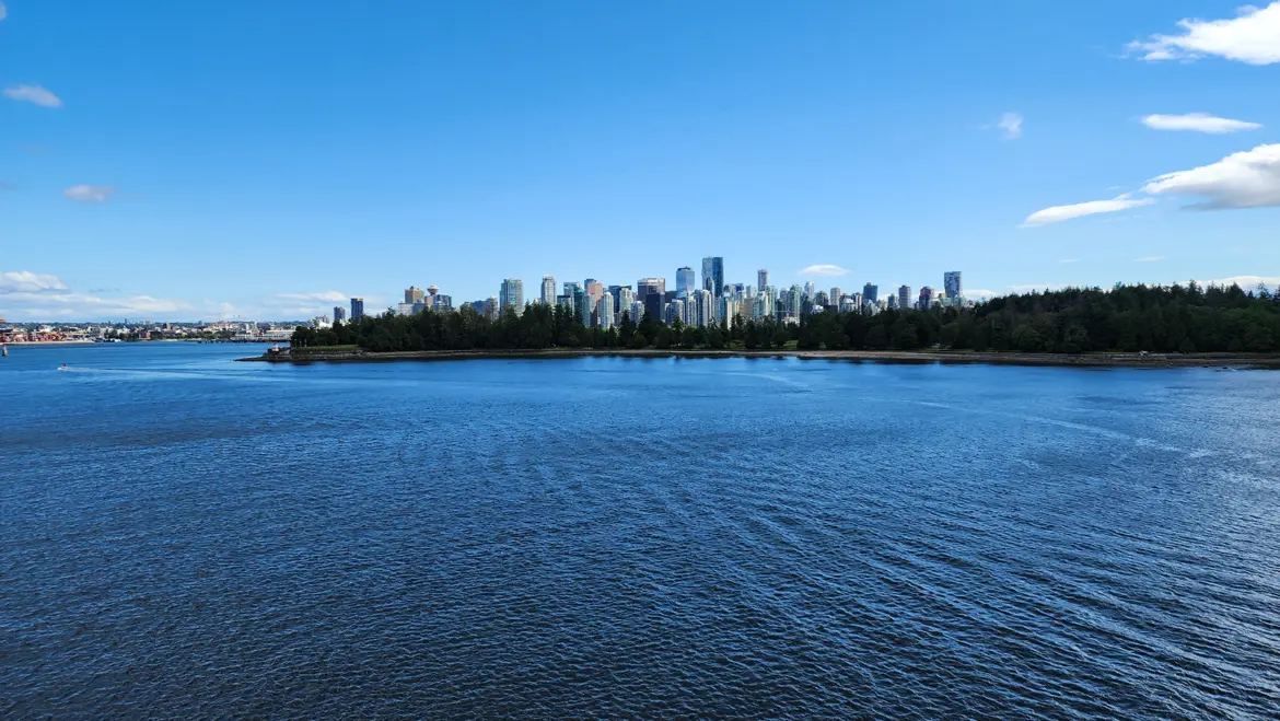 Stanley Park and the Vancouver skyline seen from the water in Vancouver Harbour